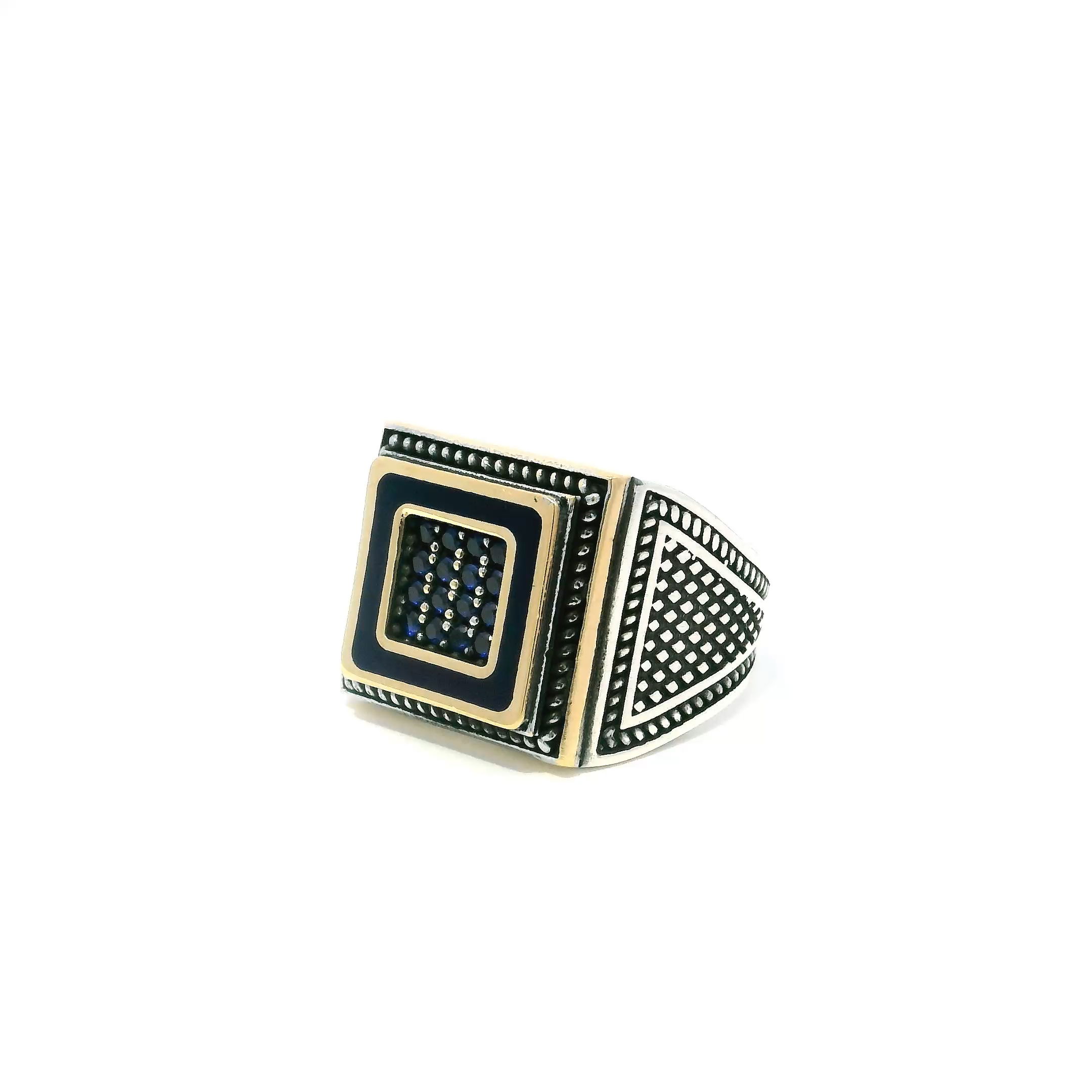 Command attention with this bold Sapphire Ring, designed for the modern man who values style and substance. Sixteen faceted round sapphire nanostones shimmer from a striking gold vermeil square centerpiece, framed by intricate rope detailing that adds texture and depth. Crafted from solid 925 sterling silver, this size 8.25 ring balances weight, comfort, and luxury with precision. Whether worn as a signature piece or for special occasions, it merges timeless craftsmanship with contemporary design—an unforgettable addition to any refined jewelry collection. Sapphire Ring - 16 Faceted Sapphire Round Nanostones Set in Gold Vermeil Square with Rope Details in 925 Sterling Silver sz8.25