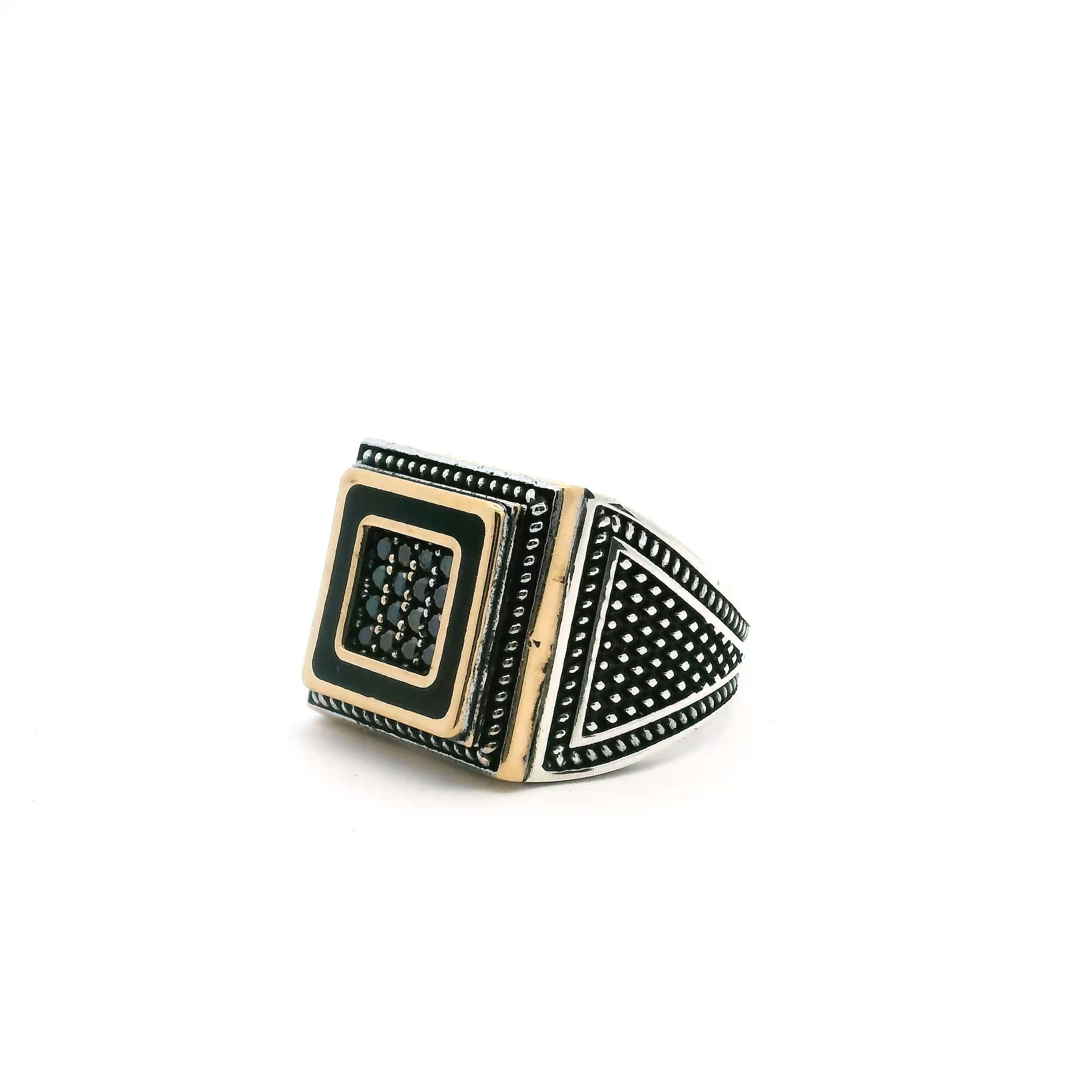 Command attention with this exquisite Black Onyx Ring, designed for the modern individual with a taste for sophistication. Sixteen faceted black onyx nanostones form a striking centerpiece, set within a bold, gold vermeil square atop a base of solid 925 sterling silver. The distinctive rope detailing along the edges adds a vintage flair, while the robust construction promises lasting wear. Sized at 8.25, this ring combines timeless elegance with contemporary style—perfect for elevating any outfit, whether formal or casual. Make a statement with every gesture; this is bold jewelry redefined. Black Onyx Ring - 16 Faceted Black Onyx Round Nanostones Set in Gold Vermeil Square with Rope Details in 925 Sterling Silver sz8.25