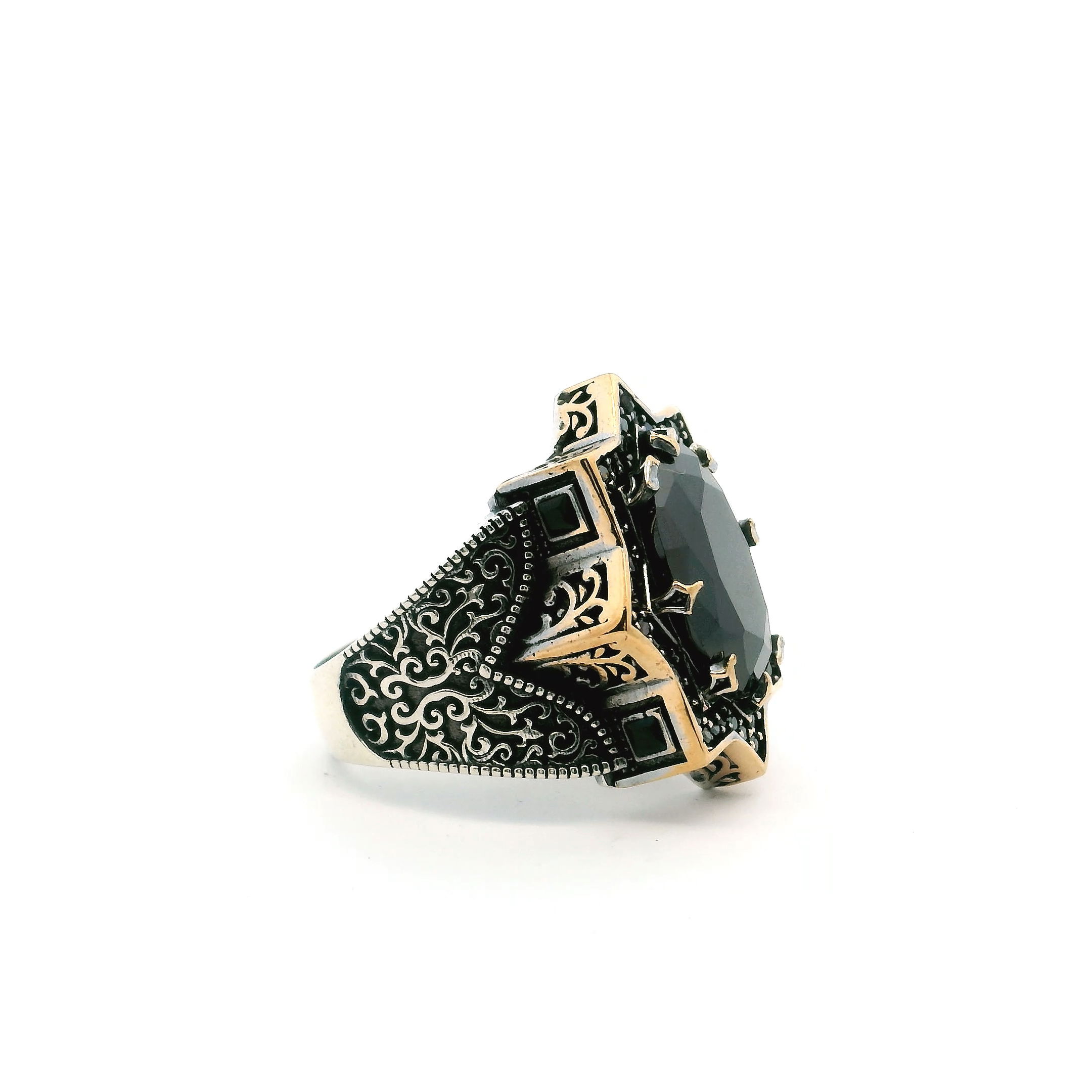 Command attention with this Black Onyx Ring, a bold fusion of strength and sophistication designed for the modern man. A faceted oval black onyx gemstone anchors the piece, prong-set within an intricately sculpted starburst that radiates confidence and precision. The band is accented with a single row of pavé-set black nanostones, offering a sleek shimmer that contrasts beautifully with swirling side motifs and fine beadwork. Crafted from solid 925 sterling silver and finished in radiant gold vermeil, this size 11.5 ring is both durable and distinguished—perfect for making a refined statement in any setting. Black Onyx Ring - Faceted Oval Prong Set in Star Design with Single Row Pave Black Nanostones & Side Swirl & Bead Details in Gold Vermeil with 925 Sterling Silver sz11.5