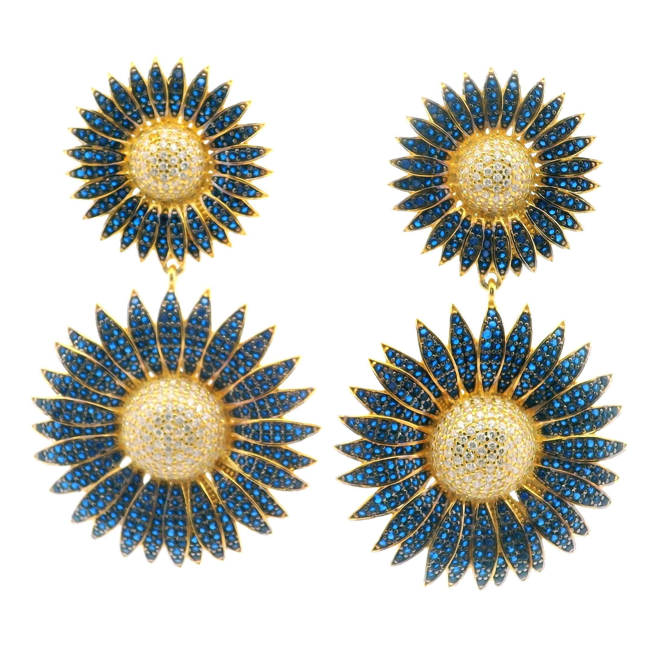 Radiate sunshine and elegance with our Sunflower Nanostone Dangle Earrings, showcasing a graceful double sunflower design adorned with shimmering blue and white nanostones. Each petal is finely detailed and brought to life with gold vermeil over solid 925 sterling silver, blending durability with refined brilliance. The delicate dangle silhouette adds gentle movement and charm, perfect for elevating both everyday ensembles and special occasion looks. A joyful tribute to nature’s beauty, these earrings bring a vibrant, whimsical touch to any jewelry collection. Sunflower Nanostone Dangle Earrings - Double Sunflowers with Blue & White Nanostones in Gold Vermeil over 925 Sterling Silver