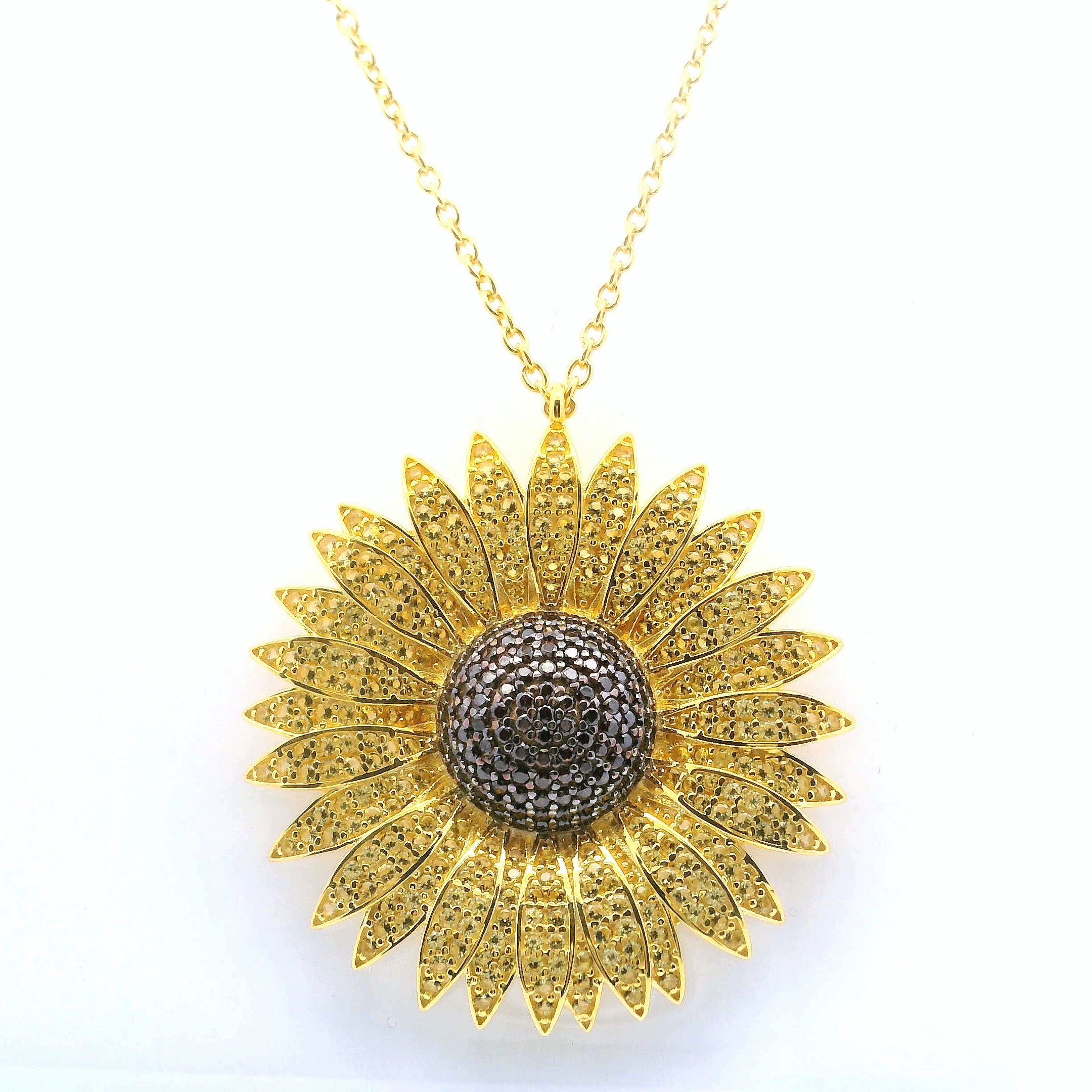 Radiate warmth and optimism with the Sunflower Nanostone Necklace, a radiant piece that captures the essence of sunlight in bloom. Vivid yellow and rich brown nanostones are meticulously set to form a lifelike sunflower, framed in gleaming gold vermeil atop solid 925 sterling silver. The pendant hangs gracefully from a delicate gold-toned chain, offering a perfect balance of charm and sophistication. Whether worn to brighten everyday looks or add a joyful accent to special occasions, this necklace is a timeless celebration of nature’s beauty and refined artistry. Sunflower Nanostone Necklace - Yellow & Brown Nanostones in Gold Vermeil over 925 Sterling Silver