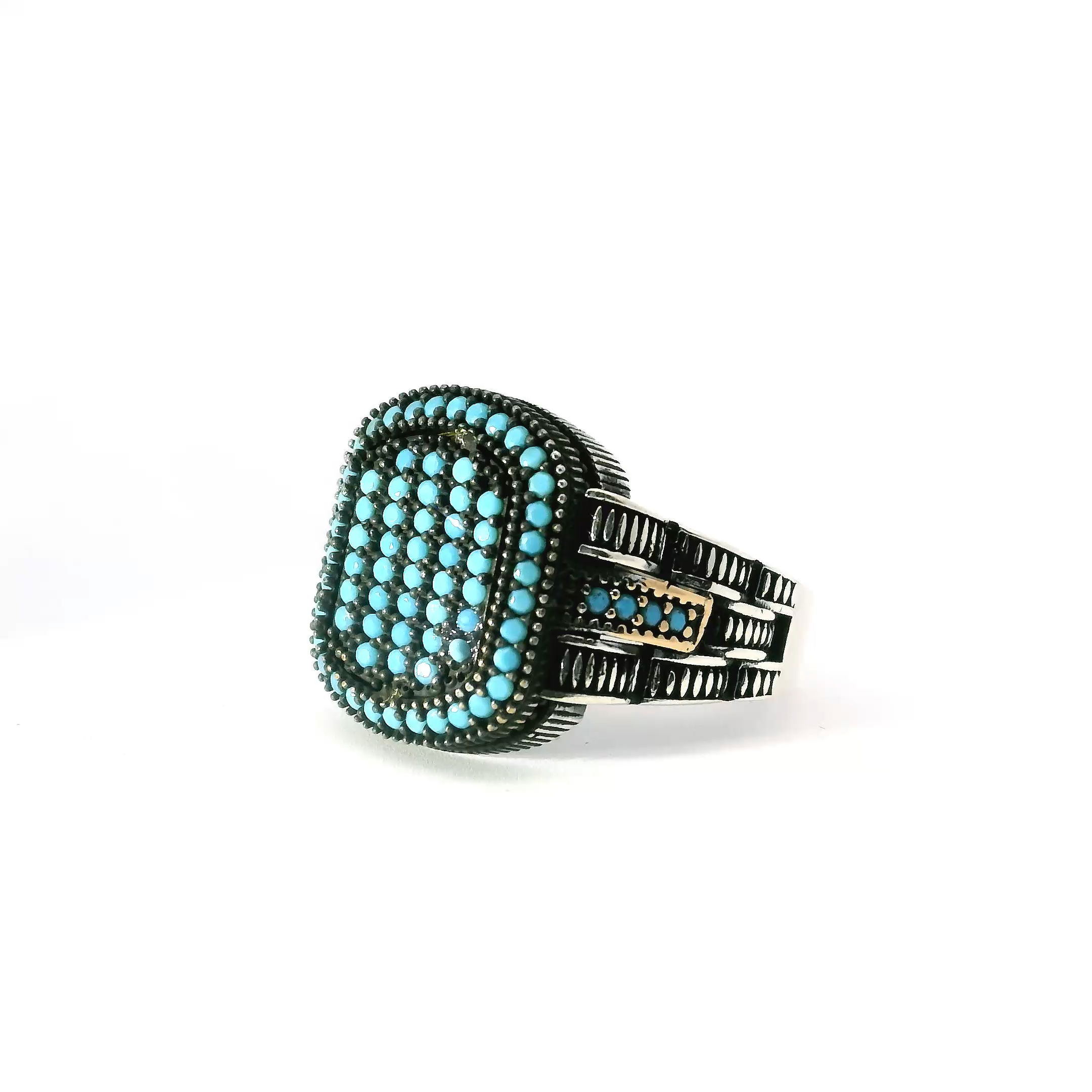 Elevate your style with the Turquoise Nanostone Ring, a bold fusion of vibrant color and modern craftsmanship. A cluster of turquoise nanostones forms the eye-catching centerpiece, framed by a shimmering halo of pavé turquoise accents that enhance its luminous depth. Rich gold vermeil details provide warmth and contrast, set atop a solid 925 sterling silver band for lasting strength and polish. Sized at 11, this striking ring is a refined statement of confidence—perfect for adding standout elegance to any look, from everyday wear to elevated occasions. Turquoise Nanostone Ring - Multiple Turquoise Nanostones Surrounded by Single Row Pave Turquoise Nanostones with Gold Vermeil Accents in 925 Sterling Silver sz11