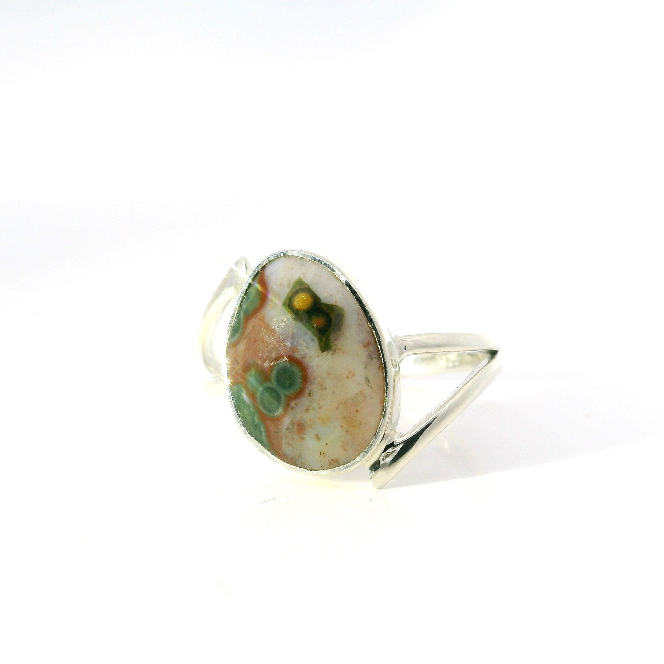 Celebrate the beauty of the sea with this stunning Ocean Jasper Ring, crafted in gleaming 925 sterling silver. The freeform faceted ocean jasper gemstone radiates unique colors and captivating patterns, bezel set for security and style. Its distinctive double offset band adds a contemporary twist, making it comfortable and eye-catching. Sized perfectly for an 8, this women’s ring is a harmonious blend of natural elegance and artisan design, ideal for adding a touch of organic sophistication to your jewelry collection. Ocean Jasper Ring - Faceted Freeform Bezel Set on Double Offset Band in 925 Sterling Silver sz8