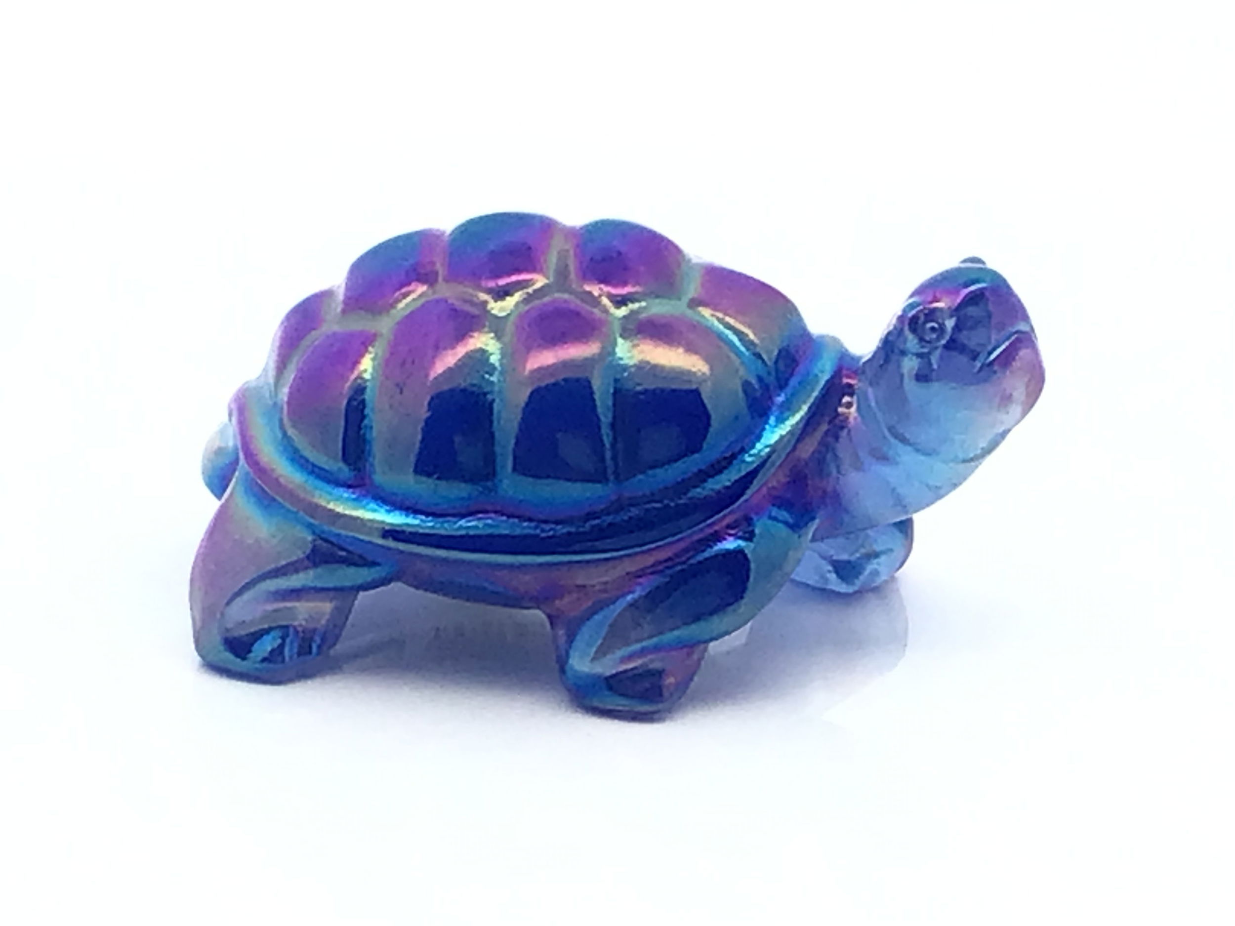 Glowing with otherworldly shimmer, the Aqua Aura Crystal Turtle Carving is a luminous fusion of oceanic grace and celestial energy. Carved from genuine Aqua Aura quartz, each turtle glistens with ethereal blues and flashes of gold—an alchemical result of bonding quartz with precious metals. Symbolizing wisdom, protection, and enduring strength, the turtle’s form becomes a vessel for peace and spiritual clarity. Whether resting on your altar, desk, or bookshelf, this radiant companion brings a tranquil presence and a touch of mysticism to any space. A treasure for crystal lovers and sea spirits alike. Aqua Aura Crystal Turtle Carving