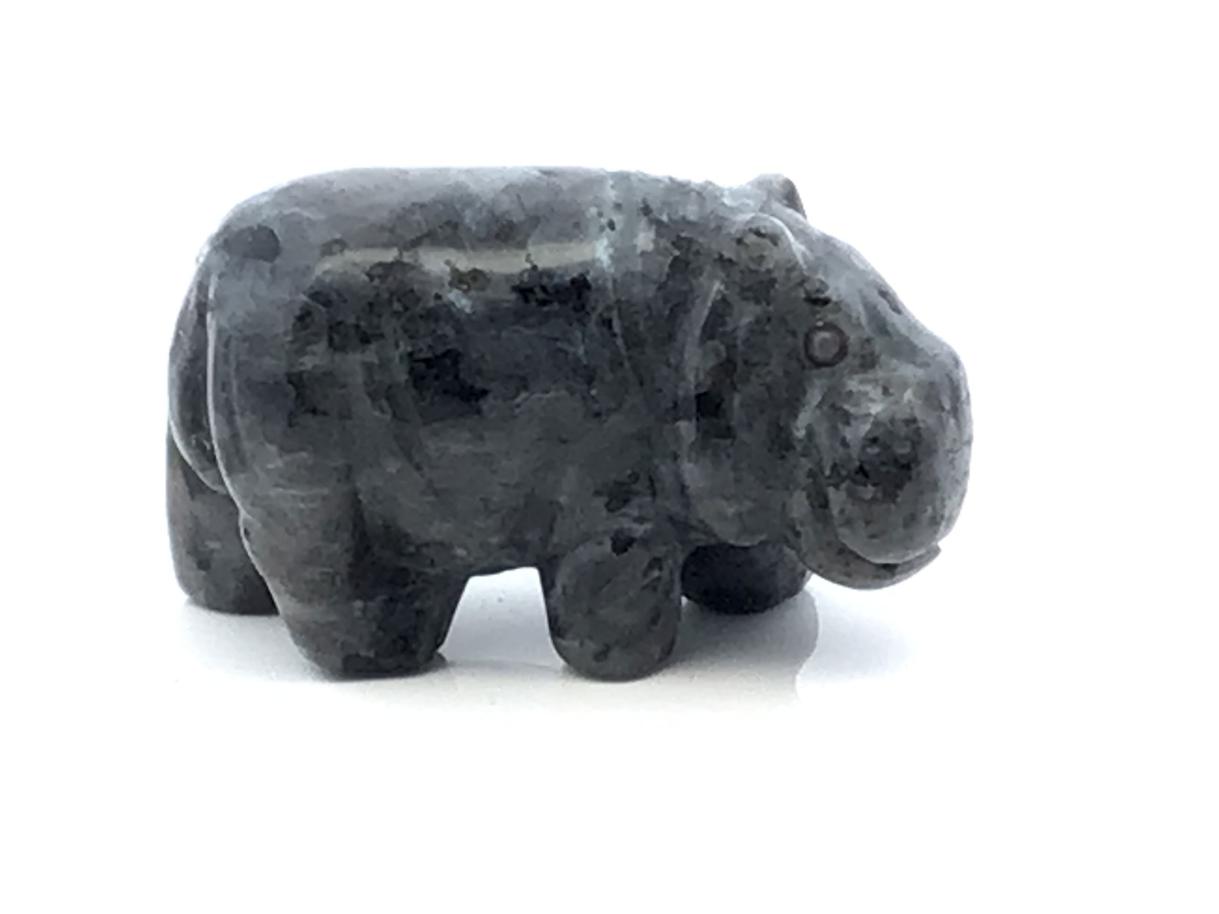 Full of quiet power and playful presence, this hand-carved Merlinite Hippopotamus is a whimsical yet grounding addition to any crystal collection. Sculpted from genuine merlinite, each figure reveals intricate black and white marbling—natural patterns that echo the stone’s reputation for spiritual insight, balance, and transformation.Compact and full of character, this hippo radiates calm strength and curious charm, making it a perfect companion for desks, altars, or sacred spaces. Whether gifted to a collector or kept as a personal talisman, this piece brings earthy magic and a sense of wonder to wherever it rests. Merlinite Hippopotamus Carving