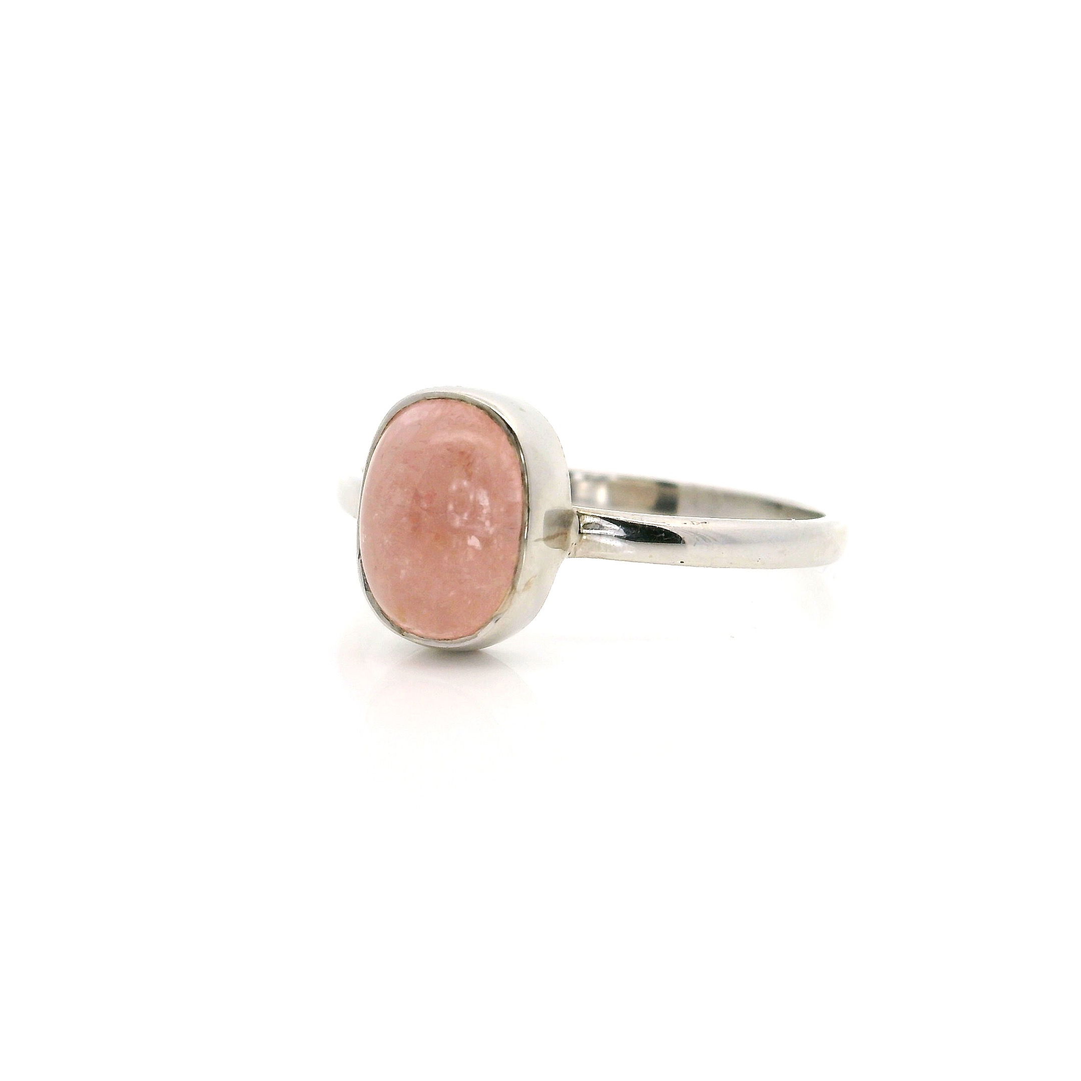 Embrace understated elegance with this stunning Morganite Ring, featuring a captivating oval cabochon morganite gemstone bezel set in polished 925 sterling silver. Designed for comfort and timeless beauty, this size 9 ring is a versatile addition to any jewelry collection, perfect for everyday wear or special occasions. The soft blush hue of the morganite radiates gentle femininity, while the simple silver setting lets the stone’s natural charm shine. Ideal for women who appreciate sophisticated and minimalist jewelry, this ring is a beautiful statement of style and grace. Morganite Ring - Oval Cabochon Bezel Set in Simple 925 Sterling Silver sz9