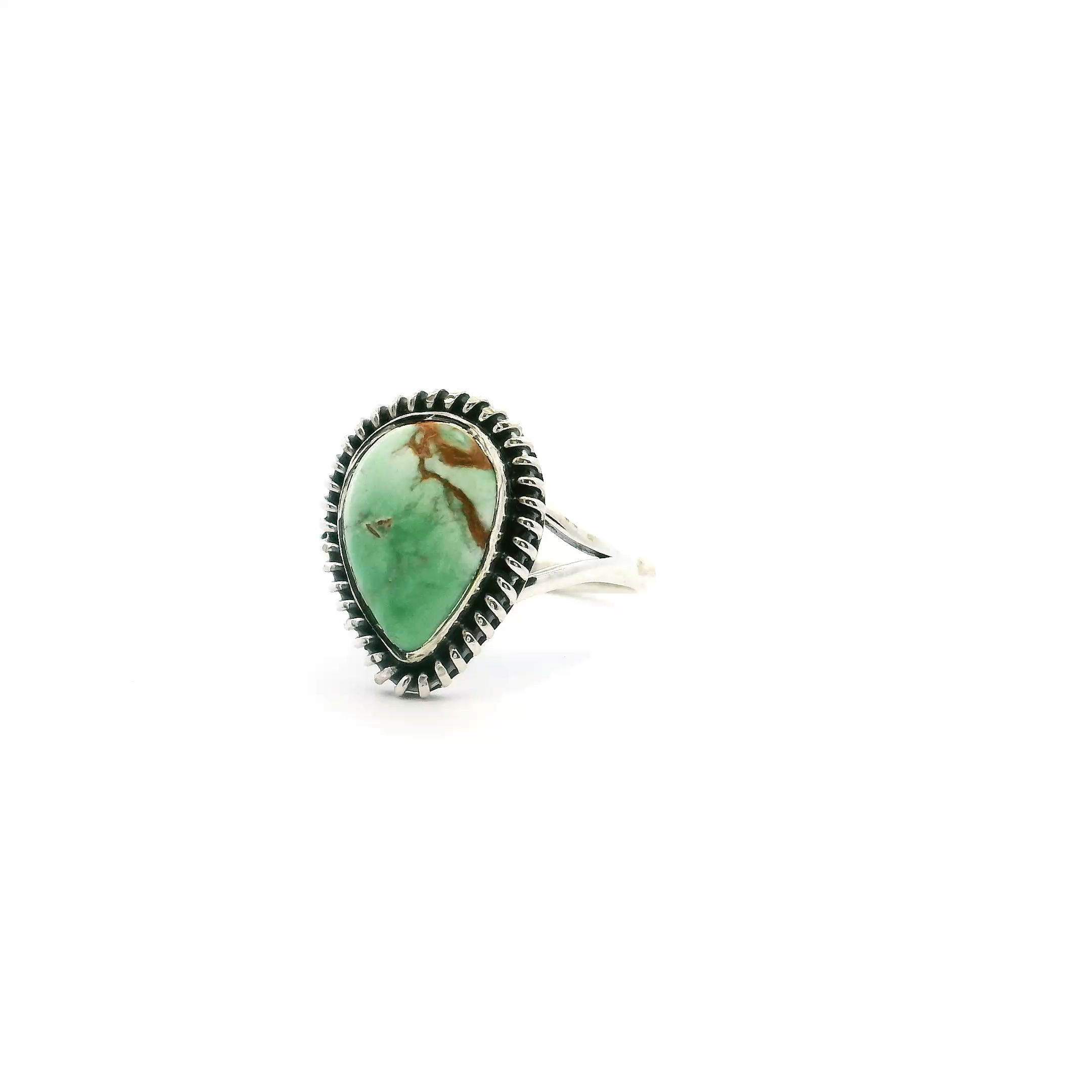 Elevate your jewelry collection with this exquisite Lemon Chrysoprase ring, crafted in gleaming 925 sterling silver. Featuring a mesmerizing pear-shaped cabochon, the gemstone displays a unique gradient—from sun-kissed caramel inclusions at the base to a lush, deeper green at the top. The bezel setting is accented with a vintage-inspired rope detail, adding a touch of artisanal charm and texture. Designed in size 6, this ring beautifully merges modern elegance with organic natural beauty, making it a statement piece for any occasion. Lemon Chrysoprase Ring - Pear Cabochon with Caramel Inclusions at Bottom & Darker Green at Top Bezel Set with Rope Detail in 925 Sterling Silver sz6