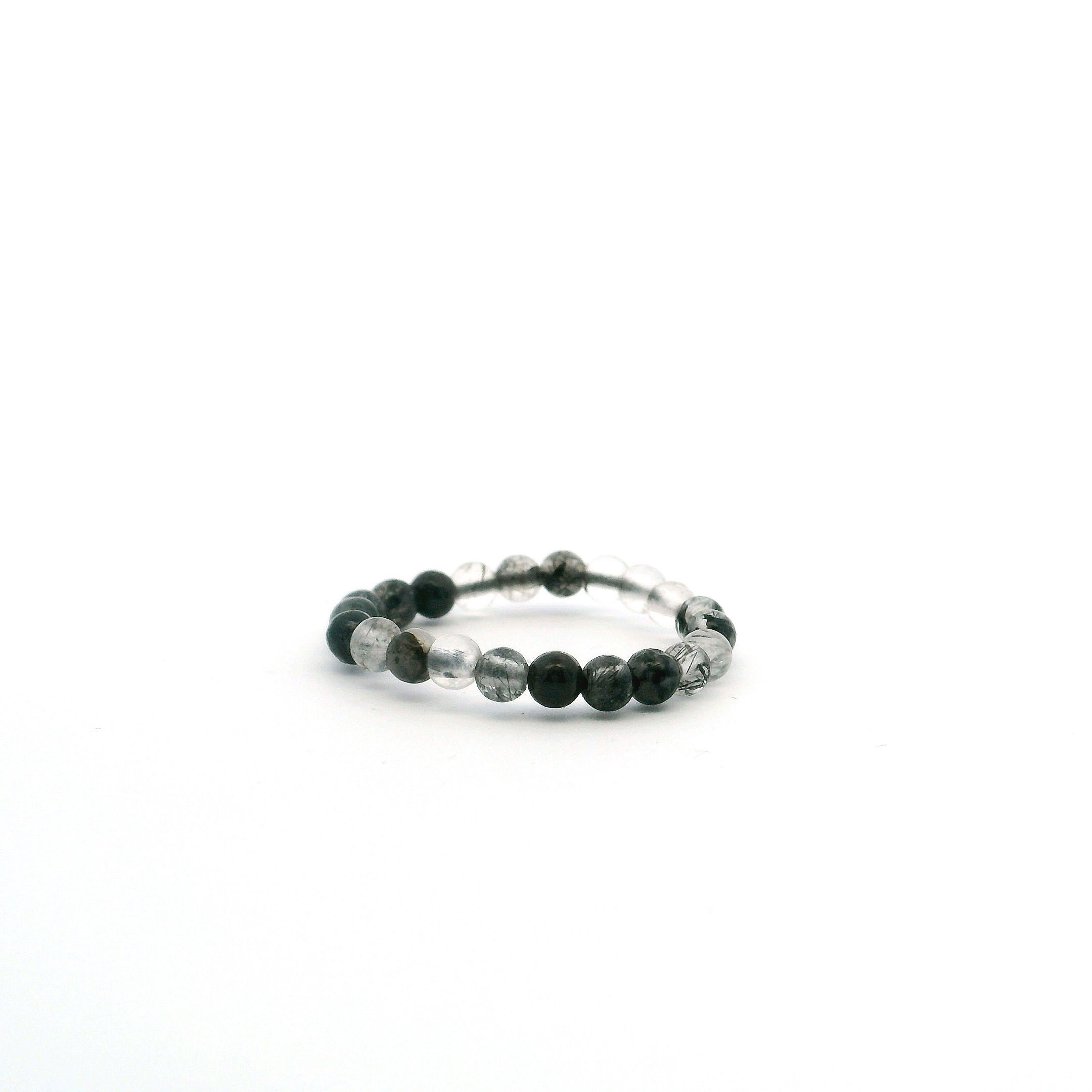 Elevate your style with the Black Tourmalated Quartz Beaded Ring, featuring 3mm round beads threaded with natural black tourmaline inclusions that create striking, one-of-a-kind patterns. Handcrafted for a sleek, minimalist fit, this ring blends delicate design with grounding energy. Perfect for stacking or wearing on its own, it’s a versatile piece that adds quiet strength and elegance to any jewelry collection—ideal for everyday wear or meaningful gifting. Black Tourmalated Quartz Beaded Ring - 3mm Round