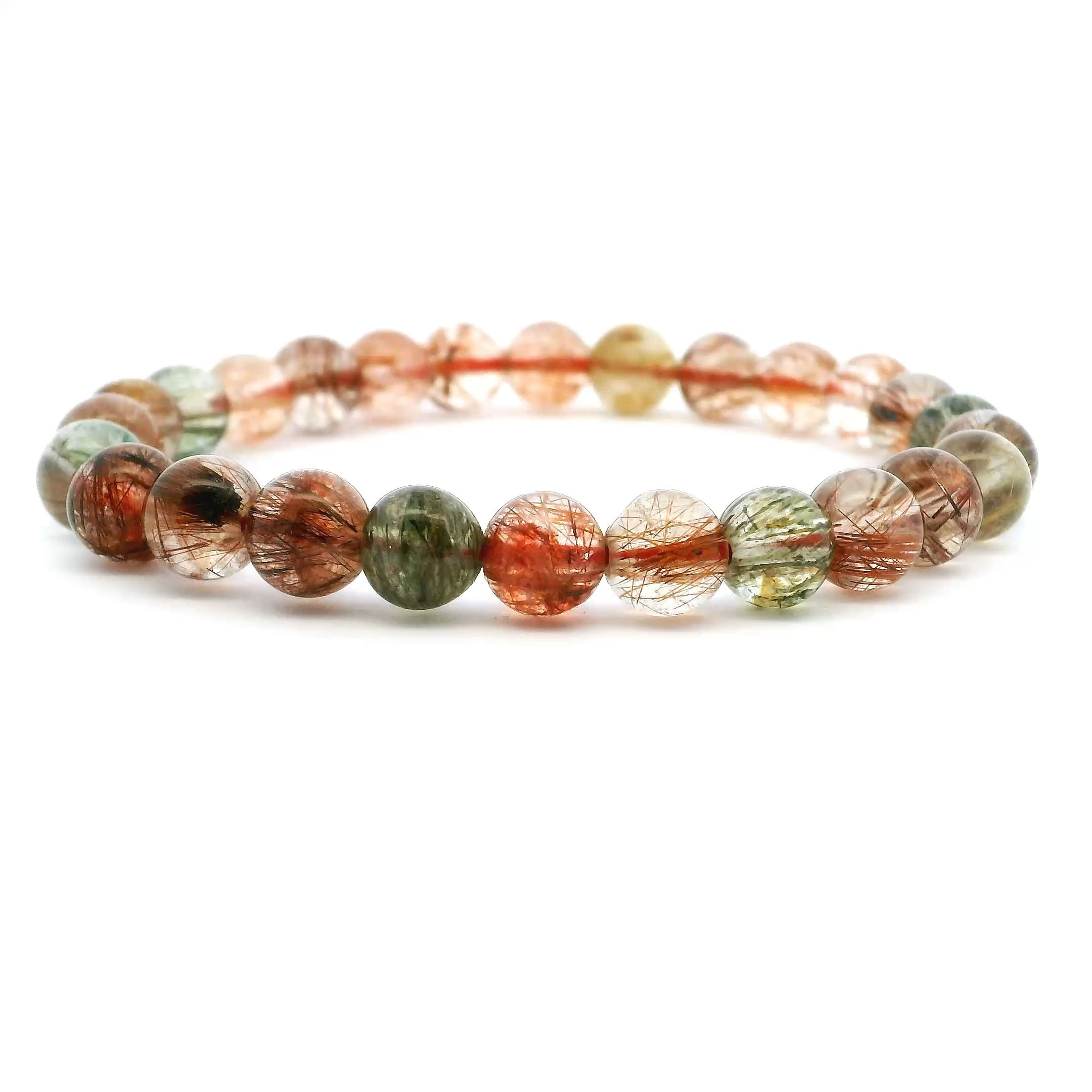 Add a touch of natural elegance to your collection with this Multicolor AA Quality Rutile Quartz Beaded Bracelet, featuring 7mm round beads infused with golden, copper, and silvery rutile threads. Each clear quartz sphere is carefully selected for its AA grade clarity and captivating inclusions, creating a harmonious blend of organic texture and refined luster. Strung on a durable elastic cord for a comfortable fit, this bracelet offers effortless versatility—perfect for stacking or wearing solo. A beautiful expression of nature’s artistry, it’s an ideal gift or a timeless addition to your personal collection. Multicolor AA Quality Rutile Quartz Beaded Bracelet - 7mm Rounds
