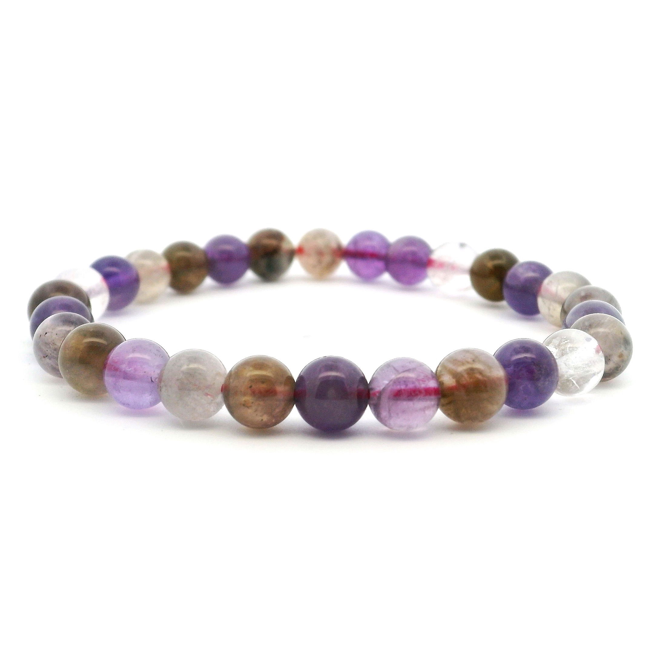 Elevate your energy and style with this Amethyst Super 7 Beaded Bracelet, featuring smooth 6–7mm round beads strung to highlight the natural brilliance of this rare crystal blend. Also known as Melody’s Stone, Super 7 combines Amethyst, Cacoxenite, Goethite, Lepidocrocite, Clear Quartz, Rutile Quartz, and Smoky Quartz in one powerful mineral matrix. Rich purples intertwine with warm earth tones in each unique bead, making this bracelet a radiant fusion of grounding, clarity, and spiritual connection. Ideal for daily wear or intentional gifting, it’s a timeless addition to any gemstone jewelry collection. Amethyst Super 7 Beaded Bracelet - 6mm-7mm Round