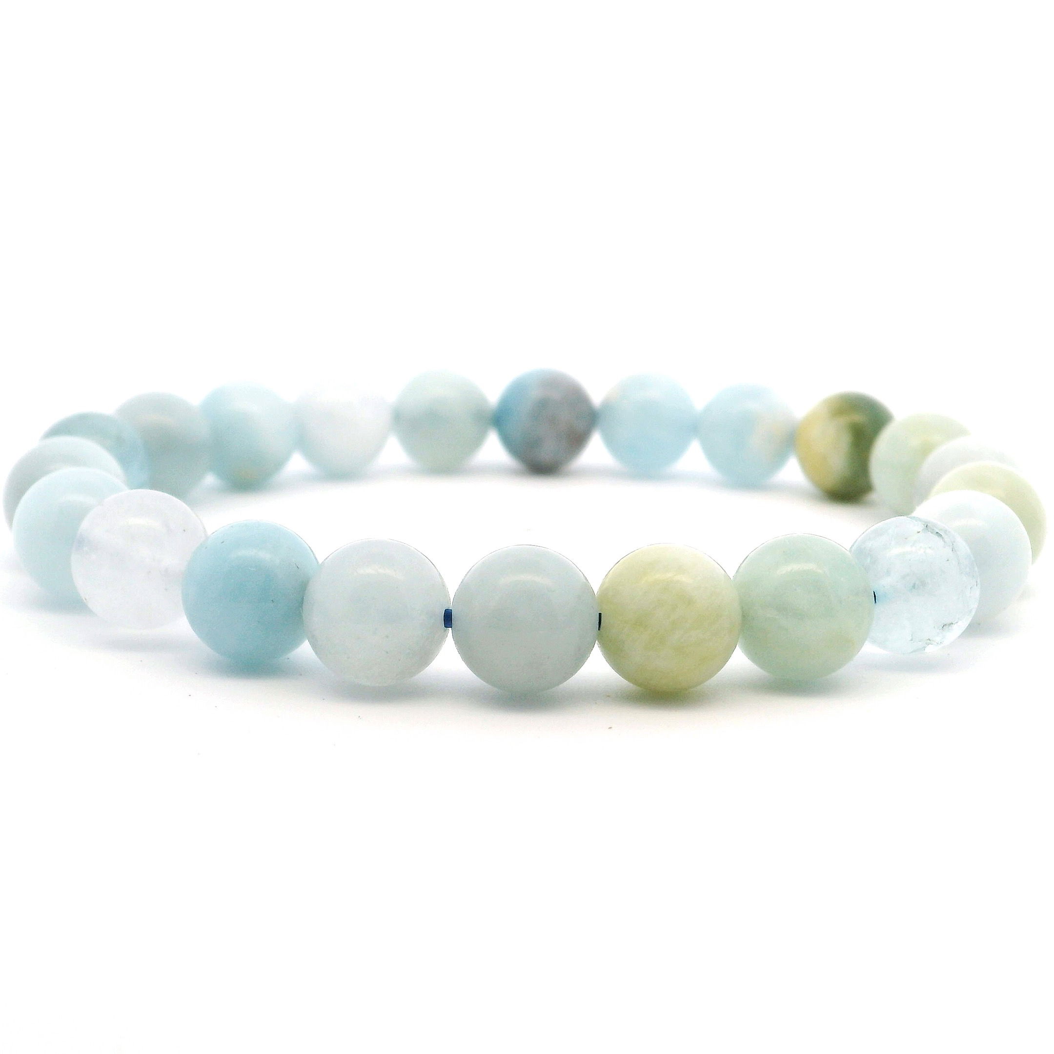 Embrace serenity and style with our Aquamarine Beaded Bracelet, featuring luminous 8mm round beads in soft, oceanic blues. Known for its calming energy and connection to clarity and peace, each polished aquamarine gemstone is hand-strung to highlight its natural translucence and gentle color variations. Set on a durable stretch cord for effortless comfort, this bracelet is perfect for layering or wearing alone as a subtle statement. A soothing, elegant addition to any jewelry collection, it makes a meaningful gift or a tranquil touch to your daily look. Aquamarine Beaded Bracelet - 8mm Round
