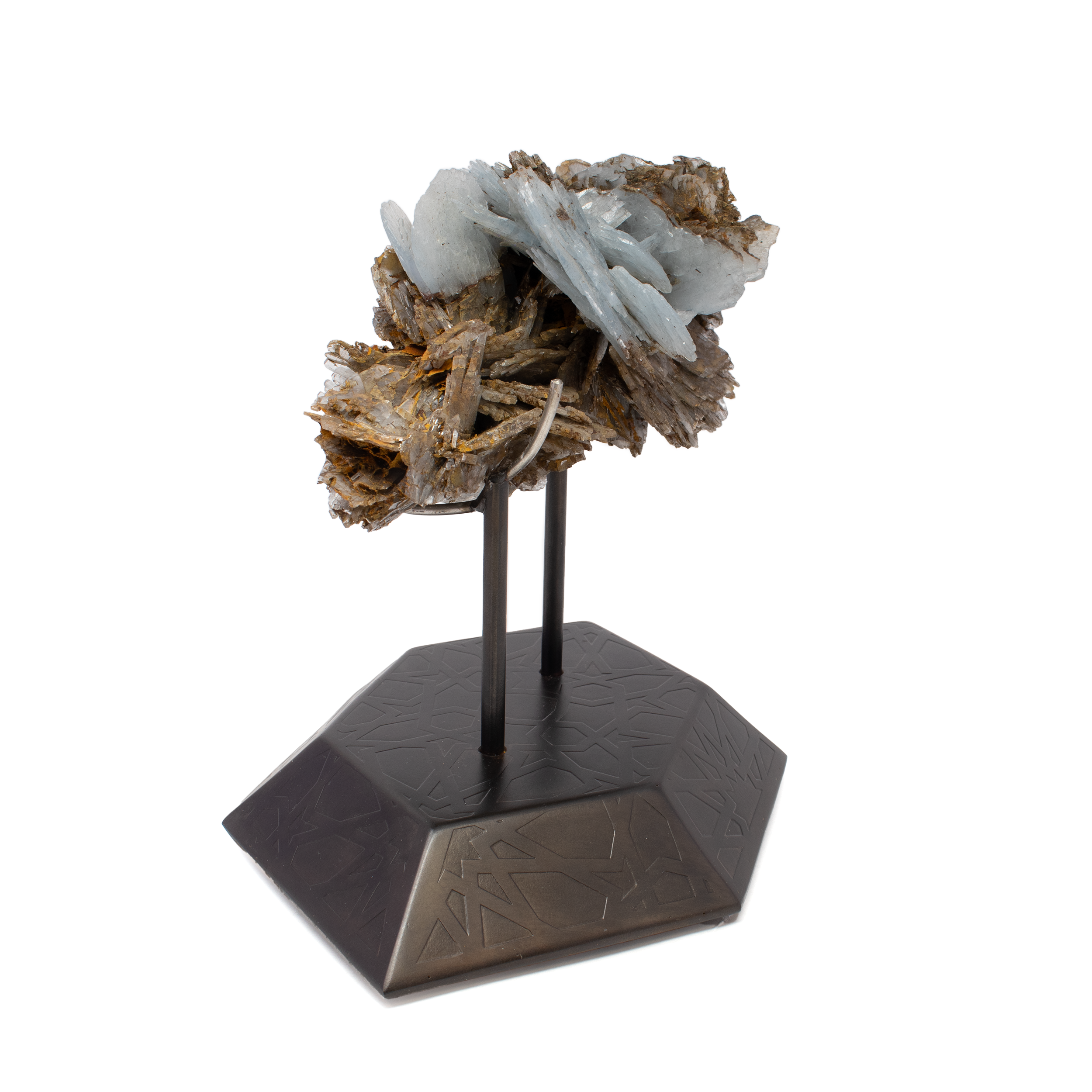 Blue Barite Crystal Specimen from Morocco on Etched Spinning Metal Stand – A breathtaking display of natural geometry and vivid color, this rare blue barite cluster radiates cool sky-blue tones in a delicate yet dramatic formation. Sourced from the renowned Moroccan mines, the specimen is securely mounted on a custom hexagonal spinning stand, etched with intricate patterns and finished in warm copper tones. Designed for 360-degree viewing, this piece invites both contemplation and admiration, blending raw mineral beauty with refined artistry. A standout addition for collectors, designers, or anyone curating a space with depth, rarity, and visual impact. Blue Barite Crystal Specimen from Morocco on Etched Spinning Metal Stand - Hexagon