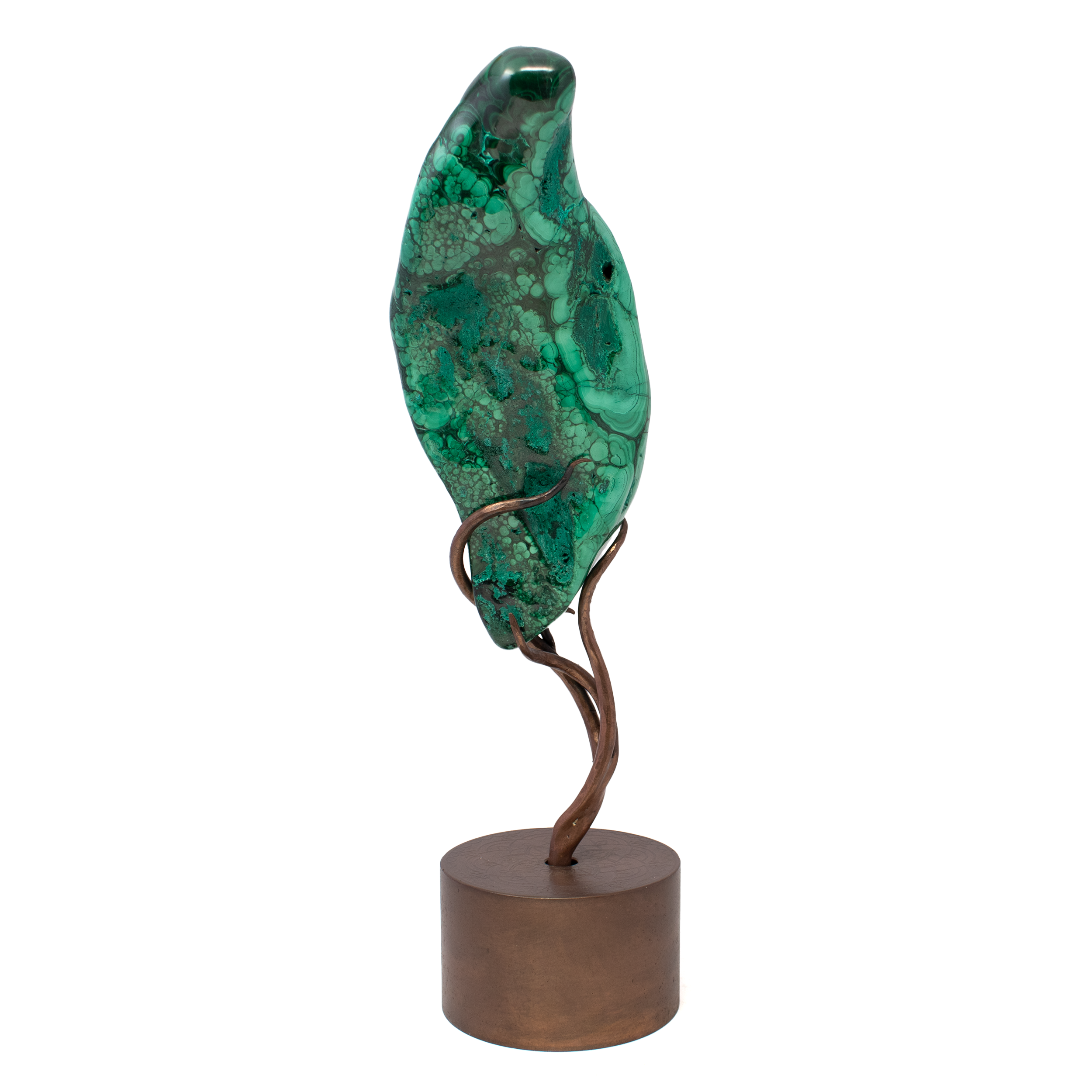 Elevate your space with this striking Chrysocolla Malachite freeform, polished to reveal vivid swirls of oceanic blue and verdant green—an exquisite fusion of copper-rich minerals. Set atop a hand-etched, rotating stand, the copper base features an intricate mandala design with a deep patina finish, marrying natural wonder with artisanal craftsmanship. Designed to spin smoothly, this display invites reflection and interaction, revealing new dimensions with every turn. Both a powerful energetic tool and a sculptural work of art, it’s ideal for collectors, healers, or anyone drawn to the beauty of earth’s most expressive stones. Each stand is individually etched, ensuring your piece is as unique as the mineral it holds. Chrysocolla Malachite on Custom Etched Spinning Stand - Polished Freeform with Mandala Etching on Coper Patina