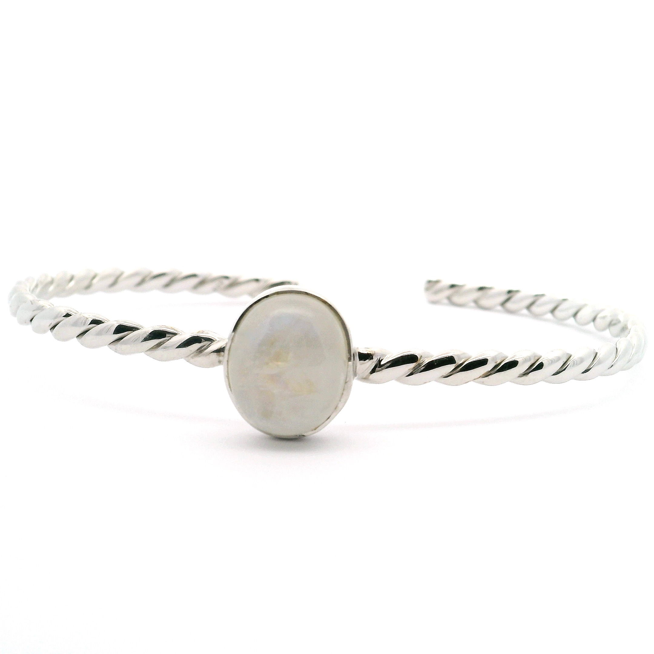 Illuminate your style with the enchanting Rainbow Moonstone Cuff Bracelet, an exquisite piece designed for the modern woman. Centered with a luminous oval cabochon rainbow moonstone, this bracelet radiates ethereal hues that dance with every movement. The gemstone is expertly bezel set atop a finely crafted 925 sterling silver band, featuring a classic twisted rope design that adds texture and elegance. Handcrafted to perfection, this cuff is both timeless and contemporary—ideal for stacking or wearing solo as a statement. Rainbow Moonstone Cuff Bracelet - Oval Cabochon Bezel Set on 925 Sterling Silver Rope Band