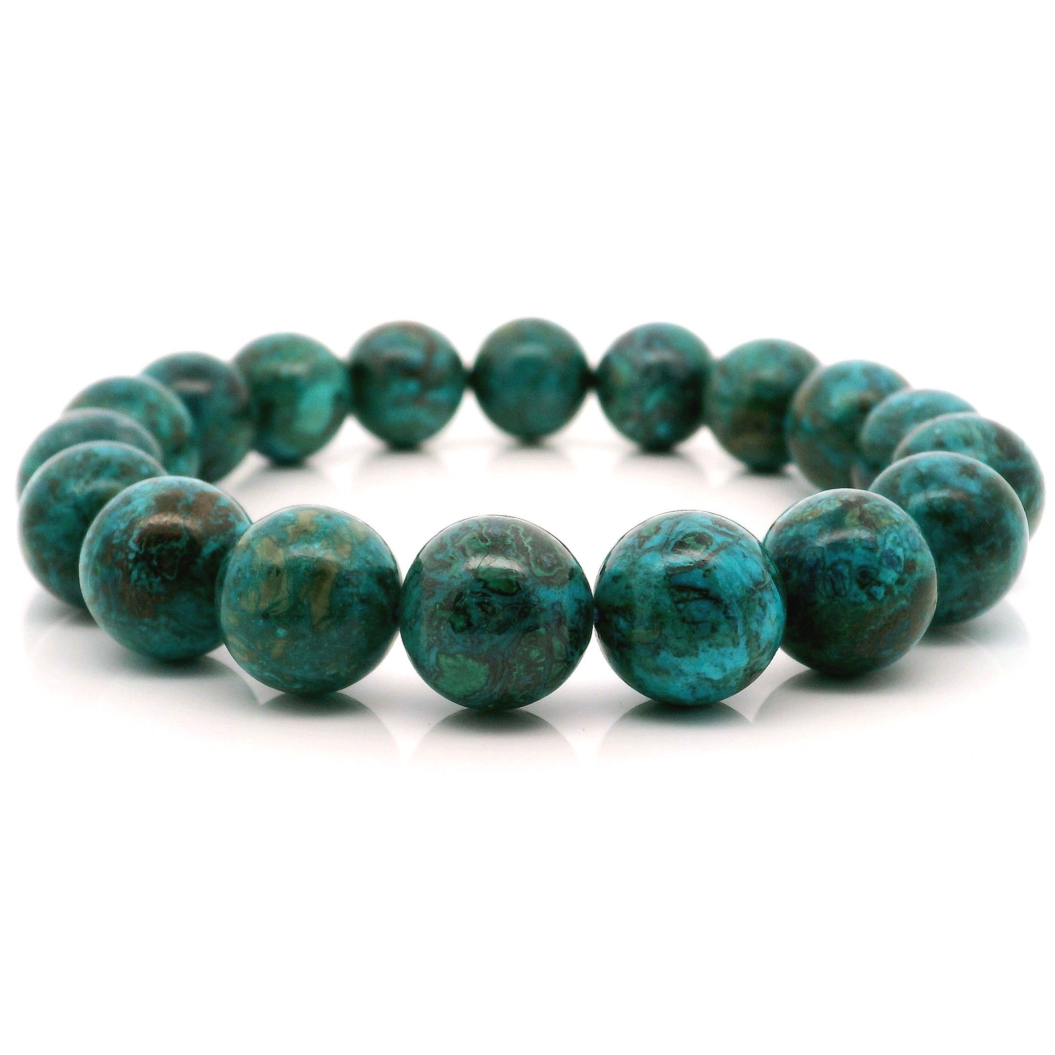 Immerse yourself in the tranquil beauty of our Chrysocolla Beaded Bracelet, featuring stunning 12mm round beads. Renowned for its captivating blend of deep blues and vibrant greens, each Chrysocolla bead is hand-selected to showcase the stone’s natural marbling and earthy elegance. Strung with care, this bracelet is both a statement piece and a tribute to timeless style. Perfect for stacking or wearing solo, it adds a touch of serene sophistication to any look. Chrysocolla Beaded Bracelet - 12mm Rounds