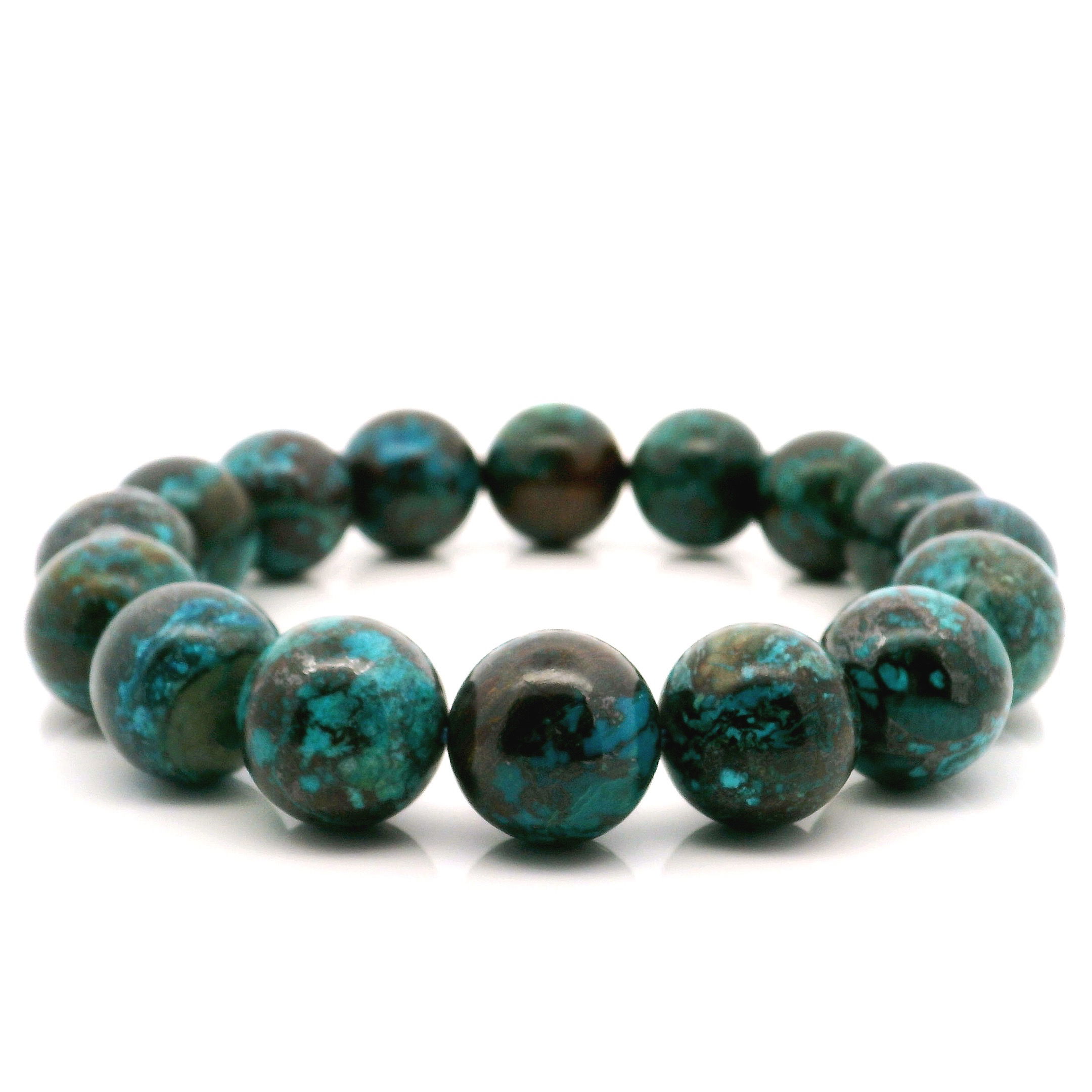 Immerse yourself in tranquil elegance with our Chrysocolla Beaded Bracelet, featuring striking 14mm round beads. Handcrafted to perfection, each bracelet showcases the unique swirls and mesmerizing hues of natural Chrysocolla—ranging from soothing blues and teals to deep greens. Known for its calming energy and connection to communication and emotional balance, this bracelet is more than just a stunning accessory—it's a statement of serenity and style. Whether worn alone or stacked with your favorite pieces, it’s the perfect addition to any jewelry collection. Elasticated for comfortable wear, this beaded bracelet fits most wrists and makes a thoughtful gift for yourself or someone special. Chrysocolla Beaded Bracelet - 14mm Rounds