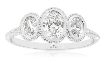 Celebrate your love with timeless elegance and contemporary style. This exquisite 14K white gold engagement ring features three oval-cut diamonds, totaling 0.75 carats, each securely nestled in a sleek bezel setting. The trio of sparkling diamonds symbolizes your past, present, and future together, making it a meaningful choice for your forever promise. With its balanced design, clean lines, and radiant brilliance, this three-stone ring offers sophisticated beauty that will be cherished for a lifetime. 14KWG 3 OVAL DIAMONDS 0.75CT BEZEL SET 3-STONE RING