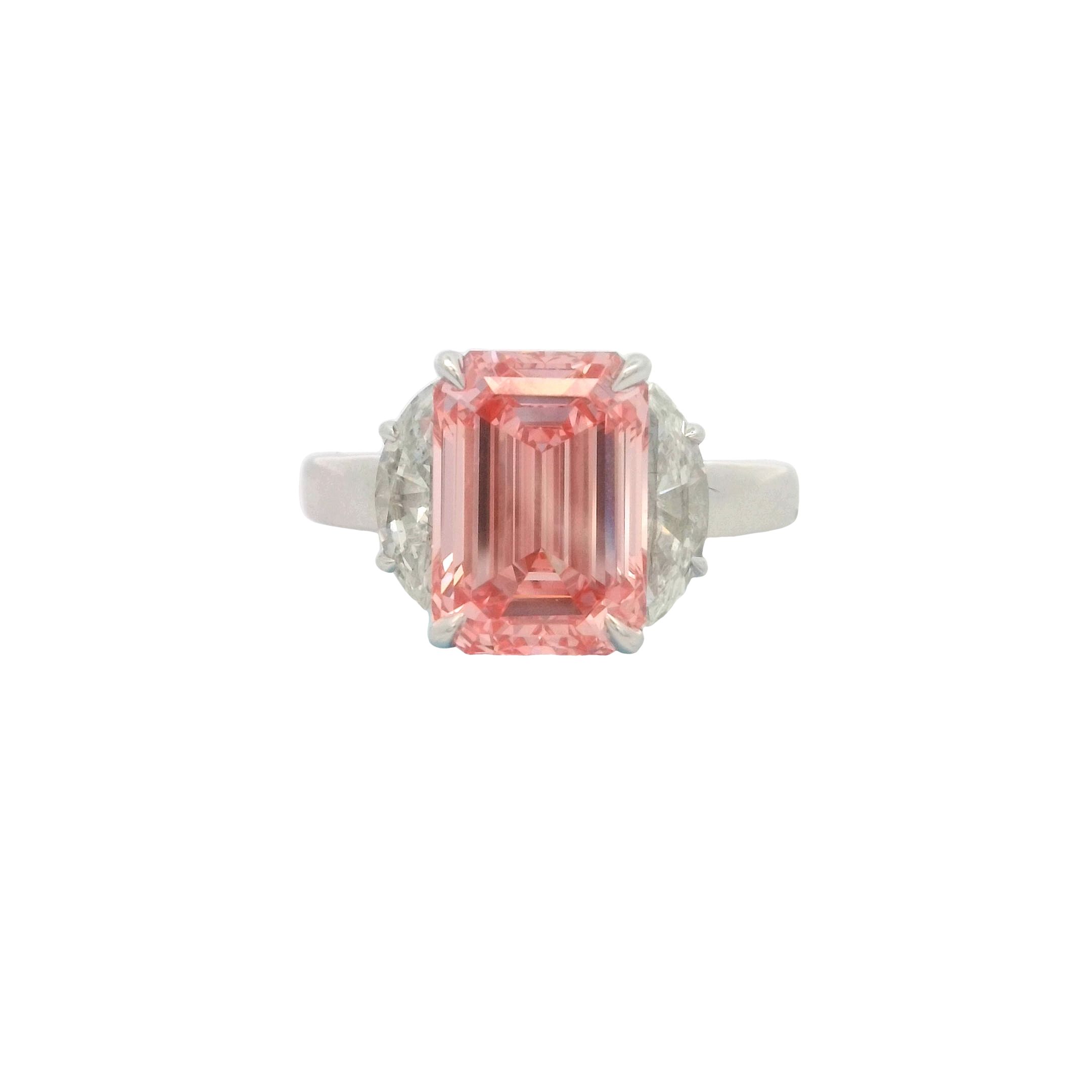 Celebrate everlasting love with this breathtaking Bellataire three-stone engagement ring, meticulously crafted in luminous 14K white gold. The showstopping centerpiece is a rare, 4.04ct fancy vivid pink emerald-cut diamond boasting exceptional VVS2 clarity—an HPHT gem that radiates captivating allure and romance. Flanked by two brilliant-cut HPHT diamonds totaling 1.07ct, this masterpiece offers exquisite sparkle from every angle. Timelessly elegant and divinely unique, it’s the ultimate symbol of love, passion, and commitment. 14K WG 4.04CT FCY V.PINK/VVS2 EMD DIA HPHT BELLATAIRE & 2 DIA'S HPHT 1.07CT 3-STONE RING