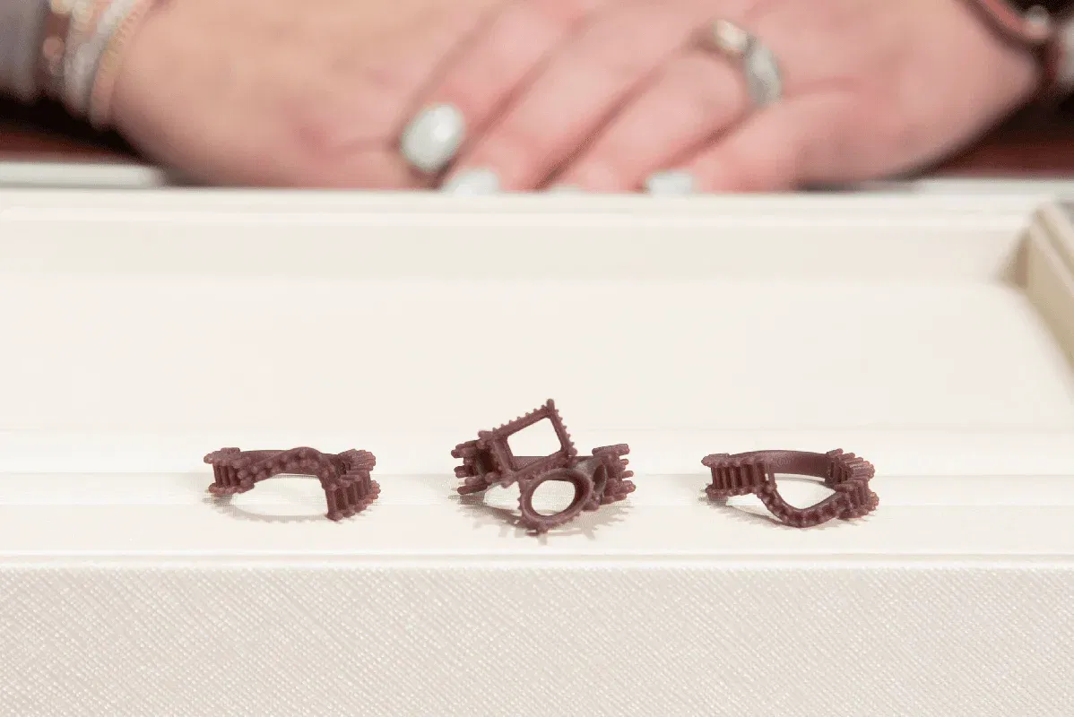 Wax mold of a custom ring being examined before casting