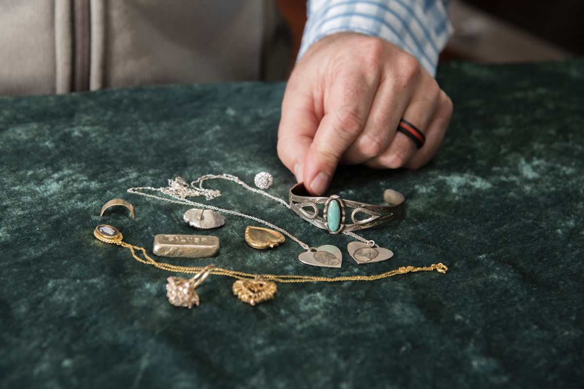 Thacker Jewelry team evaluating a customer's gold and diamond pieces at the counter