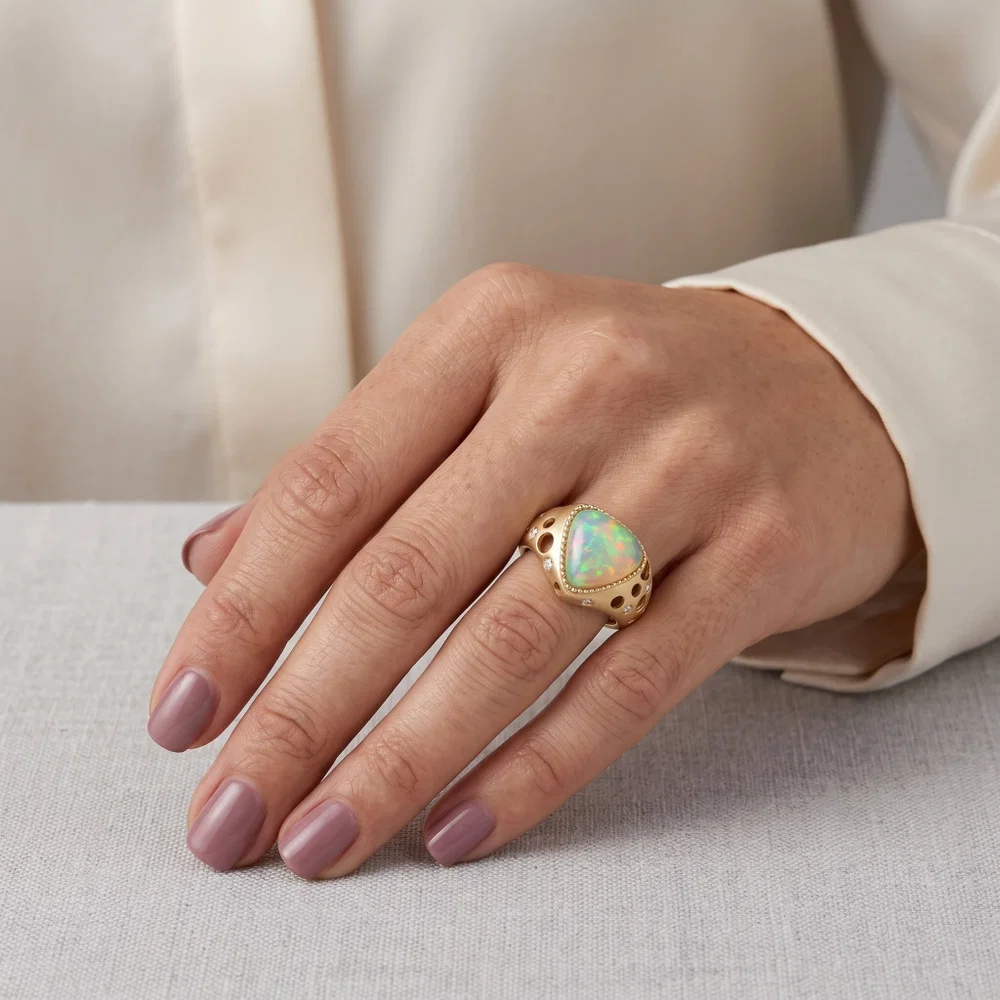 Vibrant iridescent Ethiopian opal ring set in yellow gold