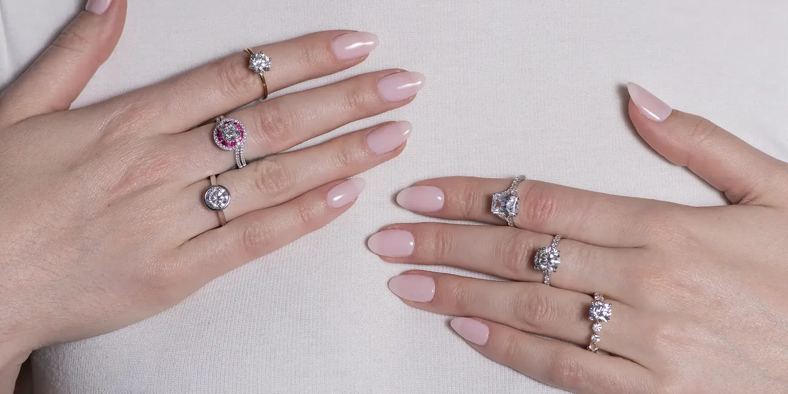 A collection of loose diamonds and fine jewelry displayed on dark velvet