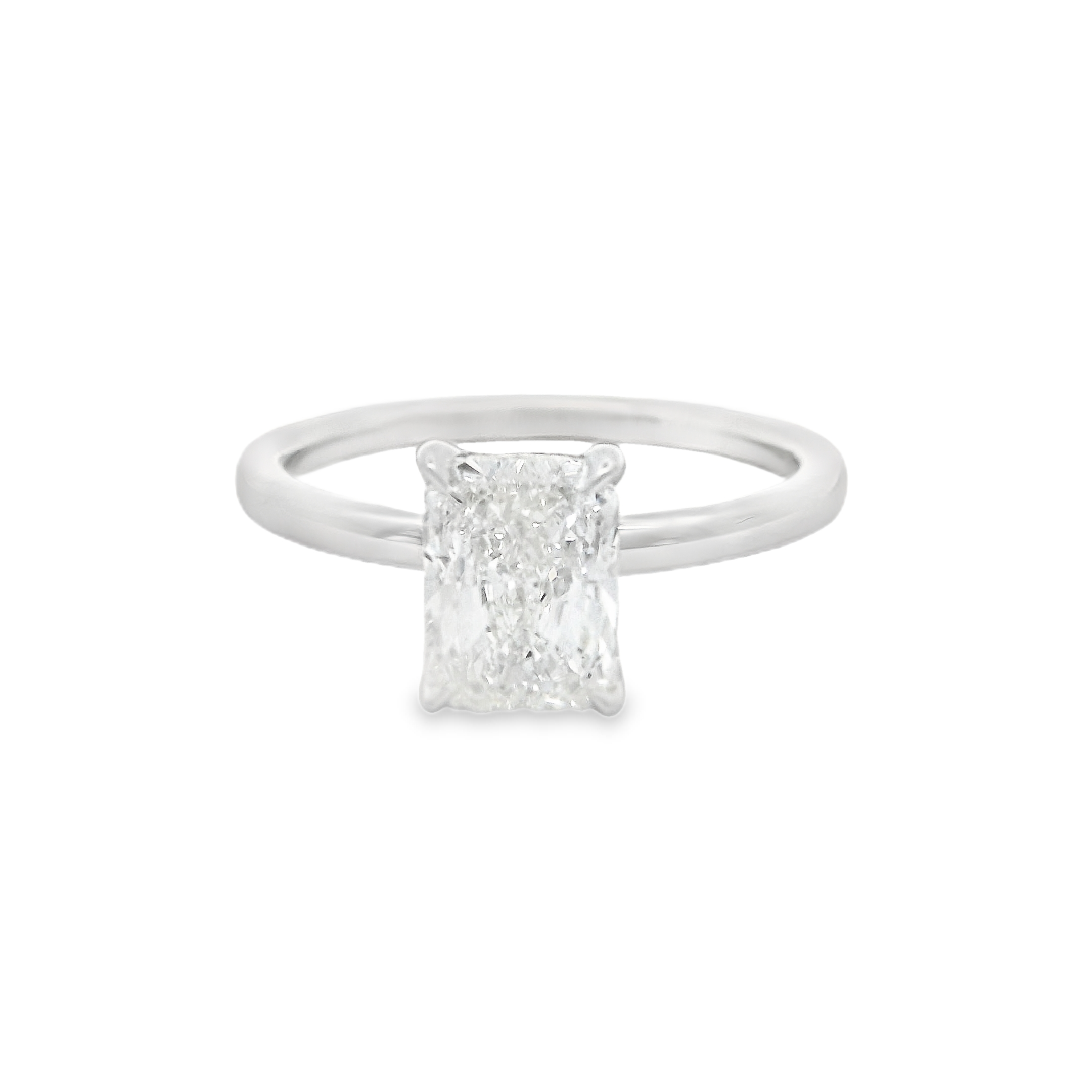 Celebrate your love with this exquisite 18K white gold solitaire engagement ring, featuring a breathtaking 1.51-carat elongated radiant cut diamond. Certified by GIA (#1495950349), this diamond shines with a captivating G color and a clarity of SI1, ensuring brilliant sparkle and sophistication. The sleek, modern setting draws all attention to the center stone’s unique silhouette and enchanting fire. Classic yet contemporary, this radiant cut solitaire is the ultimate symbol of enduring elegance and commitment. 18K wg 1.51ct Elongated Radiant Cut Diamond G/SI1 GIA#1495950349 Solitaire Engagement Ring
