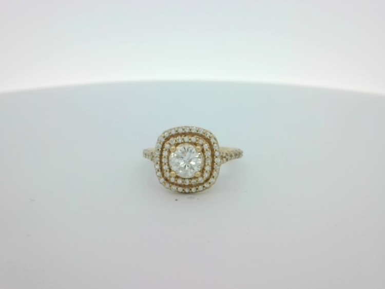 Celebrate your love with timeless elegance—this exquisite 14K Yellow Gold Double Halo Engagement Ring is designed to dazzle. Featuring a stunning 1.01-carat round brilliant center diamond, its brilliance is amplified by 68 additional round brilliant diamonds totaling 0.56 carats, intricately set in a double halo for maximum sparkle. The warm glow of 14K yellow gold beautifully complements the radiance of each diamond, creating a ring that is both classic and unforgettable. Perfect for the romantic at heart, this engagement ring is a shimmering symbol of your forever commitment. 14K YG 1.01CT BR DIA & 68 BR DIA'S 0.56CTW DOUBLE HALO ENGAGEMENT RING
