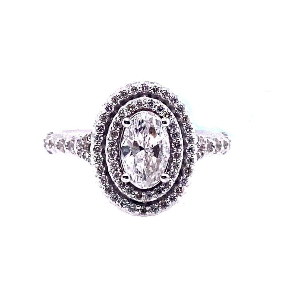 Celebrate your love with this exquisite 14K white gold engagement ring, featuring a stunning 0.69ct oval-shaped diamond as the dazzling centerpiece. The center stone, crafted using advanced HPHT technology, boasts a beautiful H color and SI2 clarity, ensuring radiant brilliance and exceptional value. Surrounding the center diamond, a double halo of 77 brilliant round diamonds (0.42ctw) adds breathtaking sparkle and amplifies its timeless elegance. Meticulously designed for lasting beauty, this sophisticated ring is the perfect symbol of your unique commitment. 14K WG 0.69CT H/SI2 OVL DIA(HPHT) & 77 BR DIA'S 0.42CTW DOUBLE HALO ENG RING
