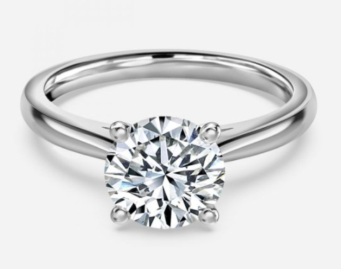 Celebrate your love with this timeless 18K white gold solitaire engagement ring, featuring a dazzling 1.20 carat round brilliant cut diamond. Graded G for color and SI1 for clarity, the center stone radiates exceptional brilliance and sparkle, perfectly set to capture every eye. Crafted with precision and elegance, this classic diamond ring is a symbol of everlasting commitment, making it the perfect choice for your unforgettable proposal. 18KWG 1.20CT G/SI1 ROUND BRILLIANT CUT DIAMOND SOLITAIRE ENGAGEMENT RING