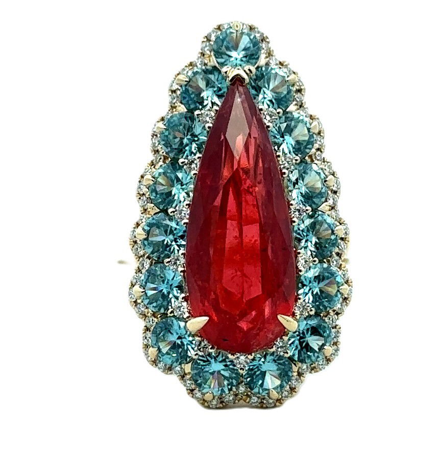 18KY 7.57CT PEAR SHAPE RHODONITE -- 15 ROUND BLUE ZIRCON 3.72CT & 74 ROUND DIAMONDS 0.34CT HALO RING