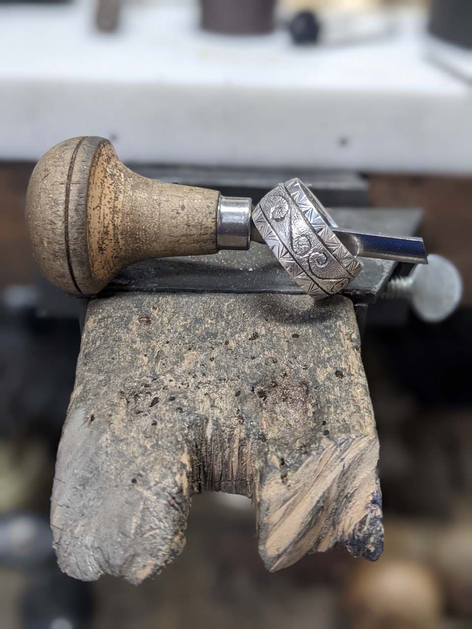 A ring held in a bench vise for repair