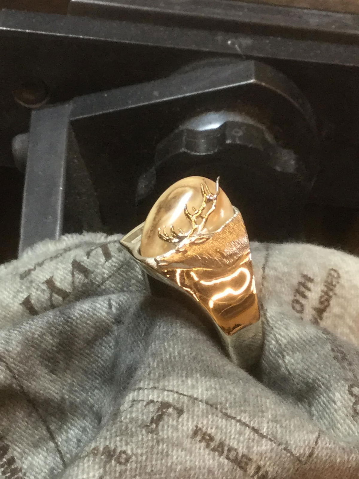 A gold ring with the letter r on it