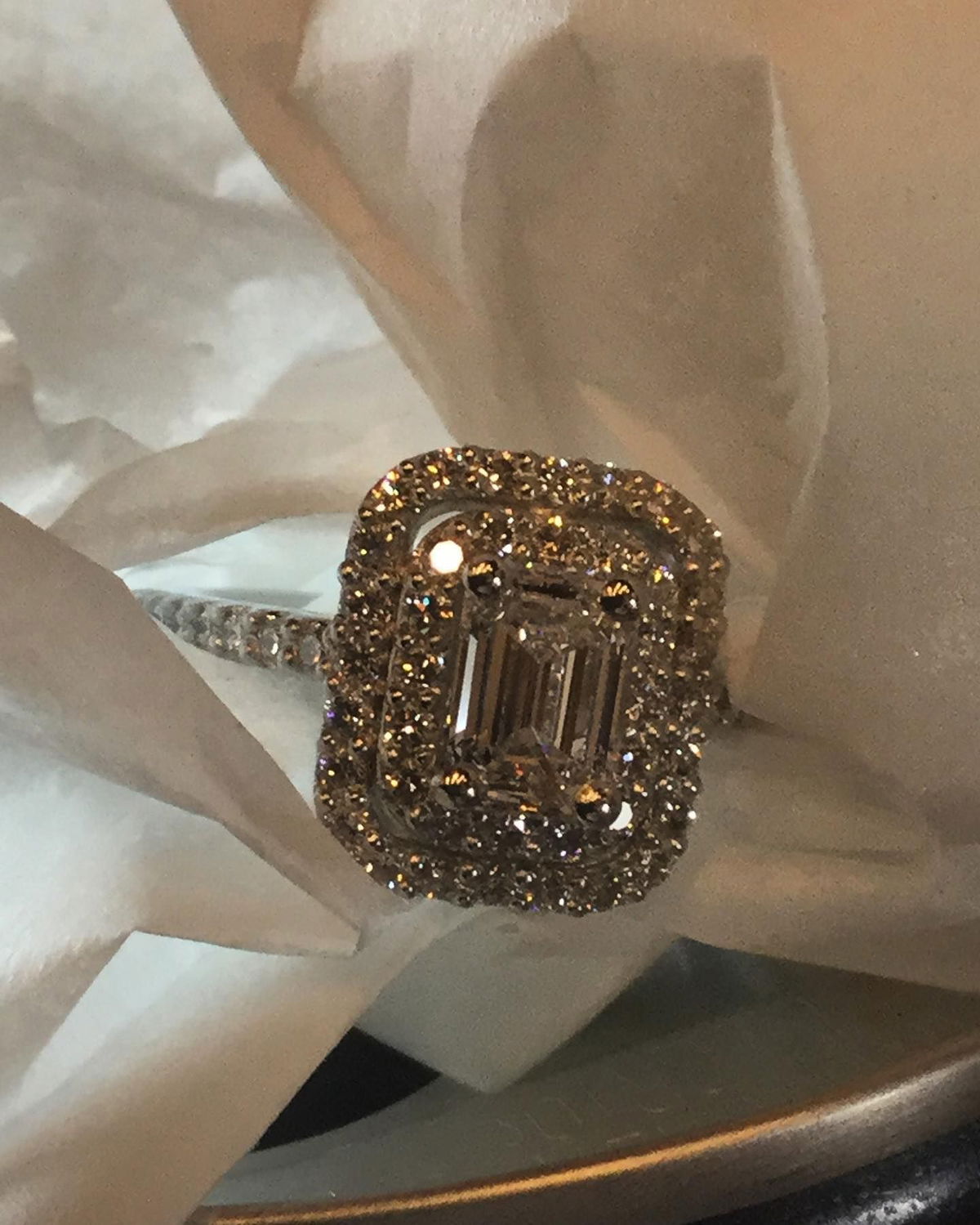 A diamond ring is sitting on a piece of paper