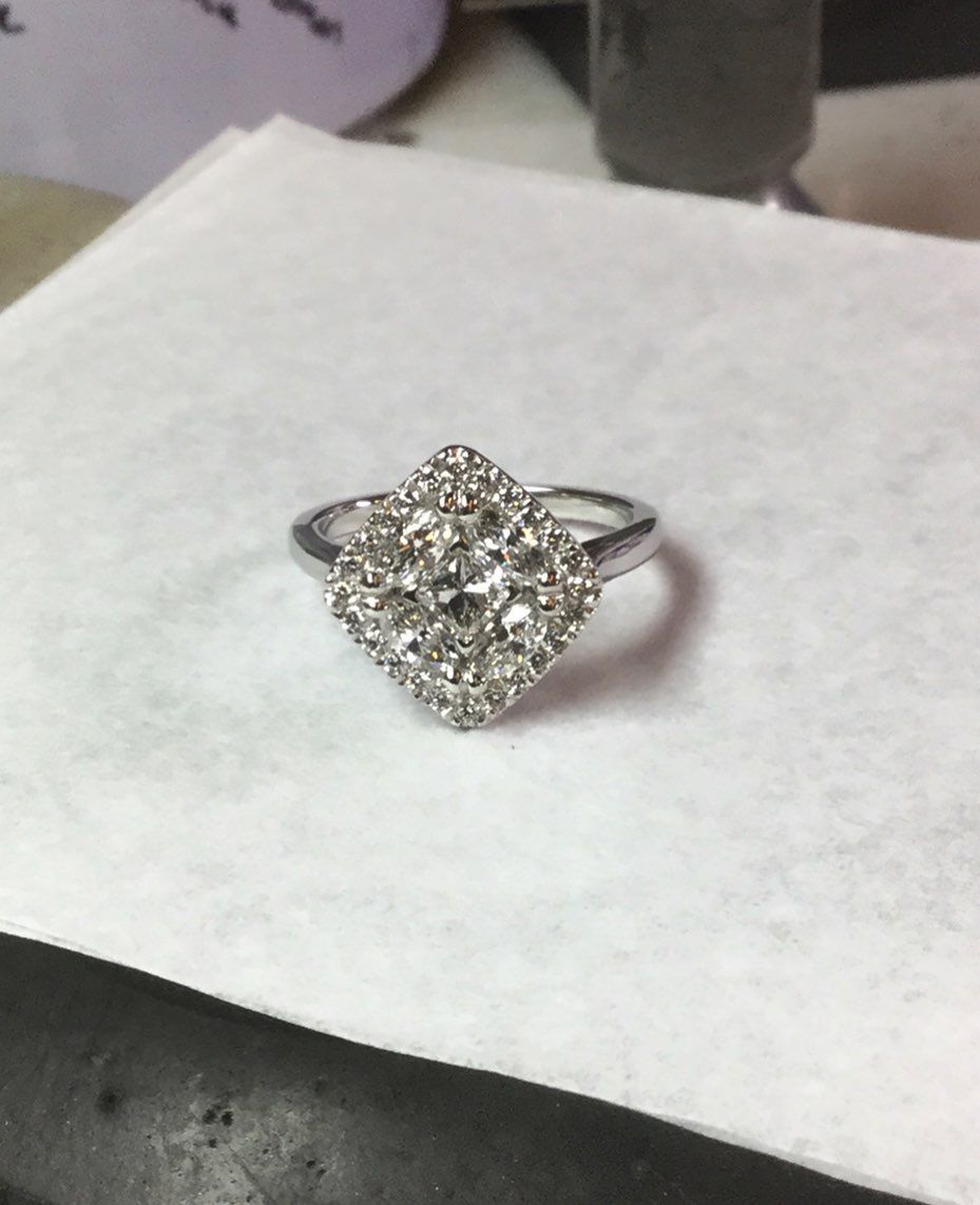 A diamond ring is sitting on a piece of paper