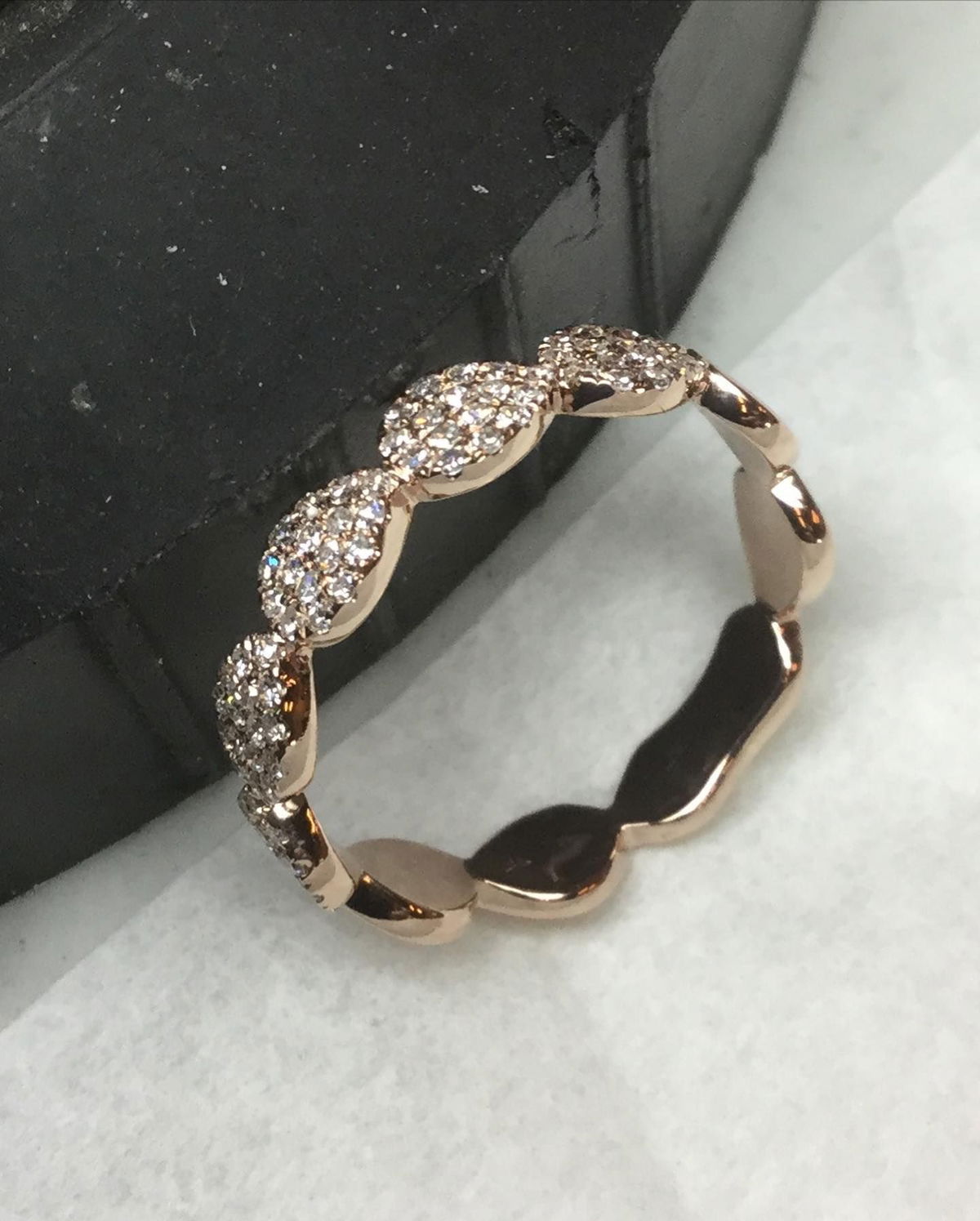 A close up of a ring with diamonds on it