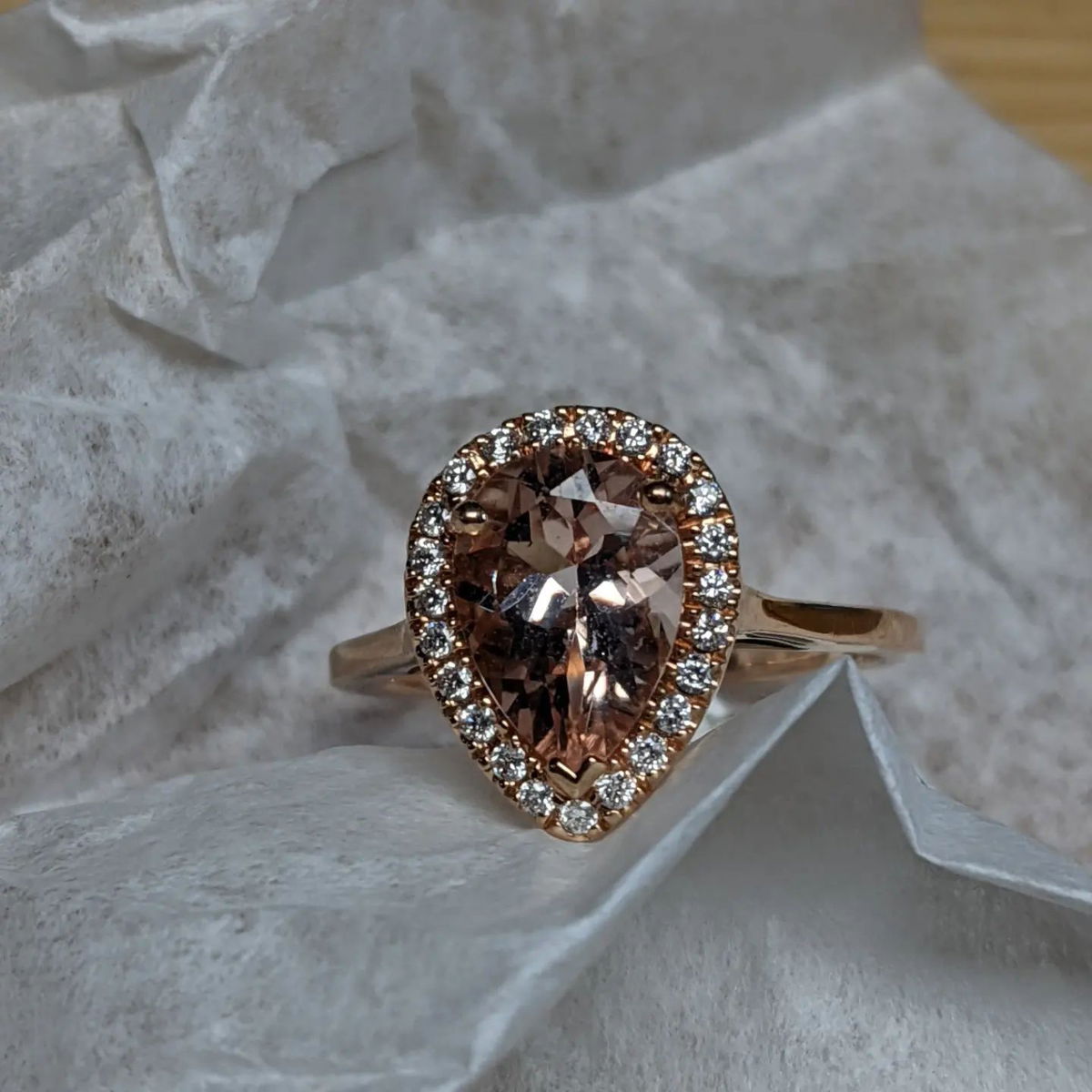 A ring with a pear shaped stone and diamonds