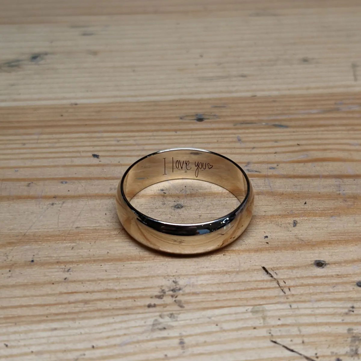 A gold ring with the words