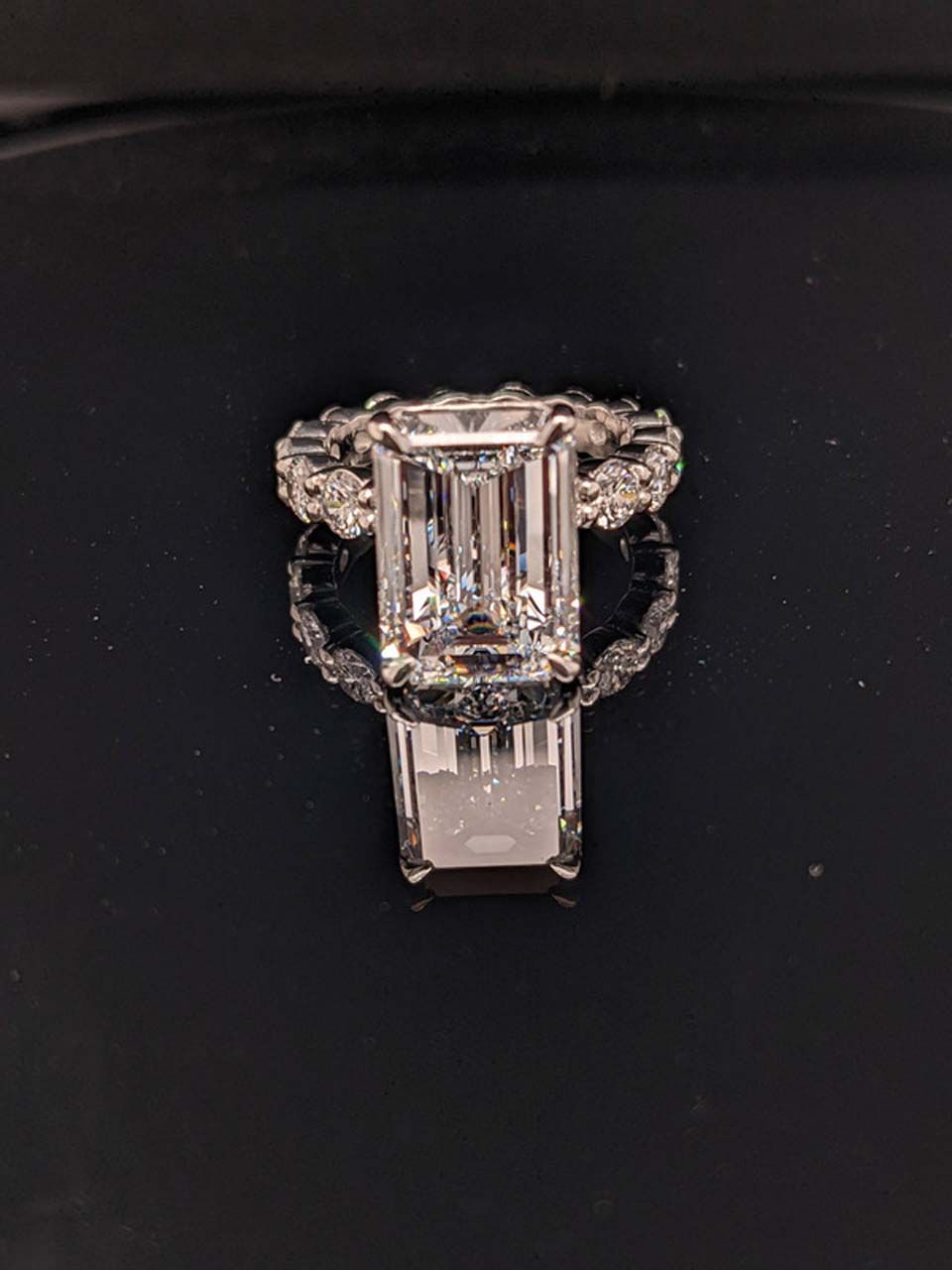 An emerald-cut diamond ring in a halo setting
