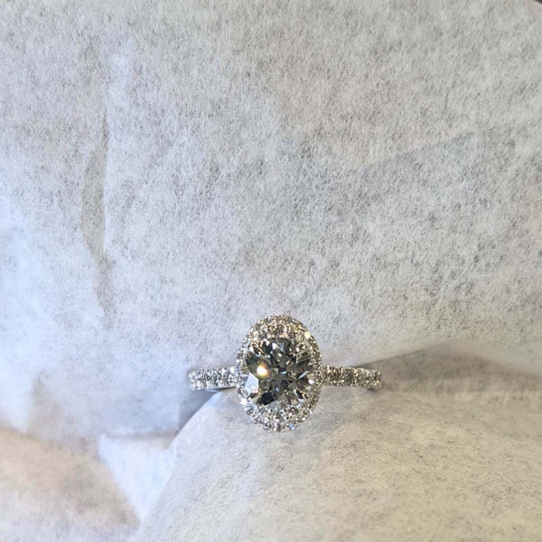 A diamond ring is sitting on a piece of paper.