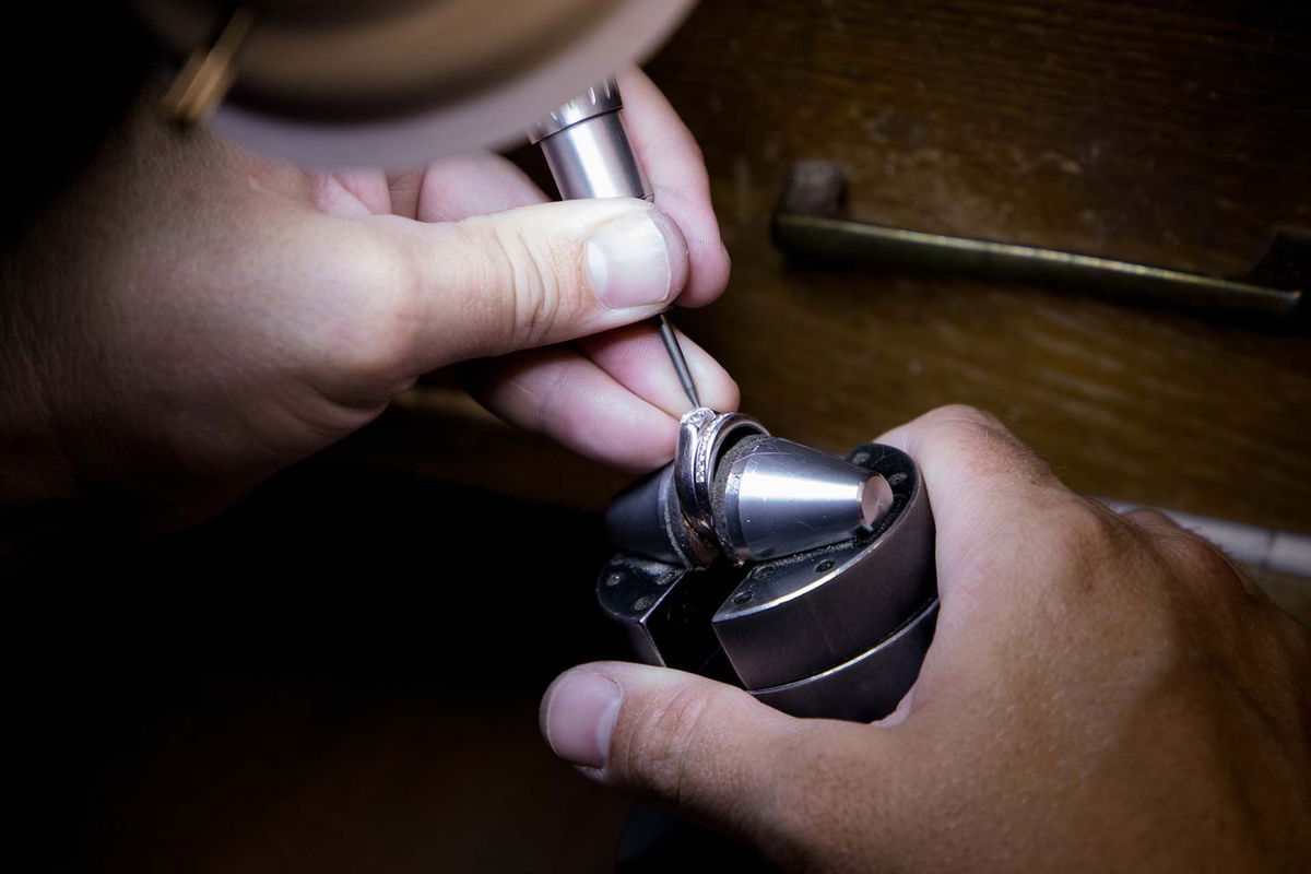 A jeweler working on a ring at the bench