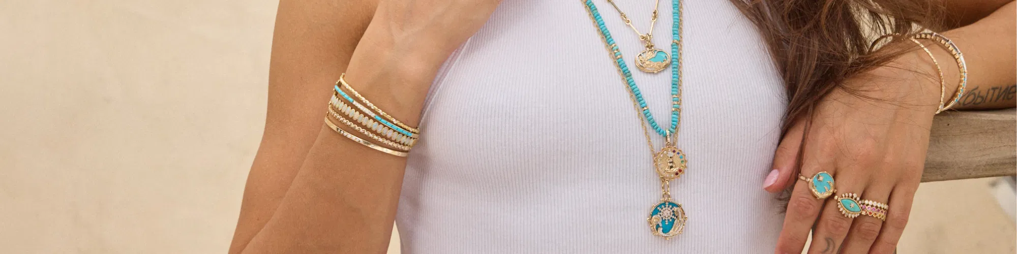 Three Stories Jewelry artisan gold pendant necklaces on natural linen