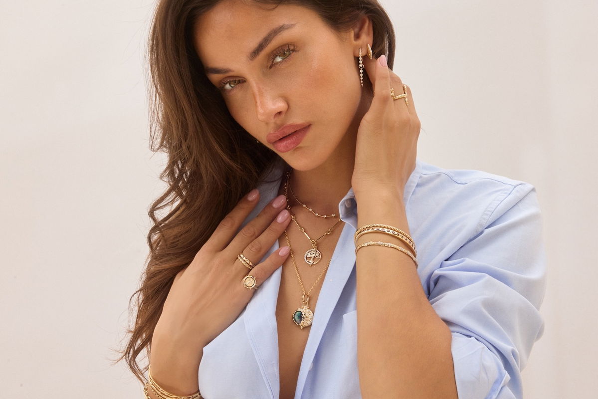 Exquisite gold pendant necklace on linen with radiant gemstone detailing
