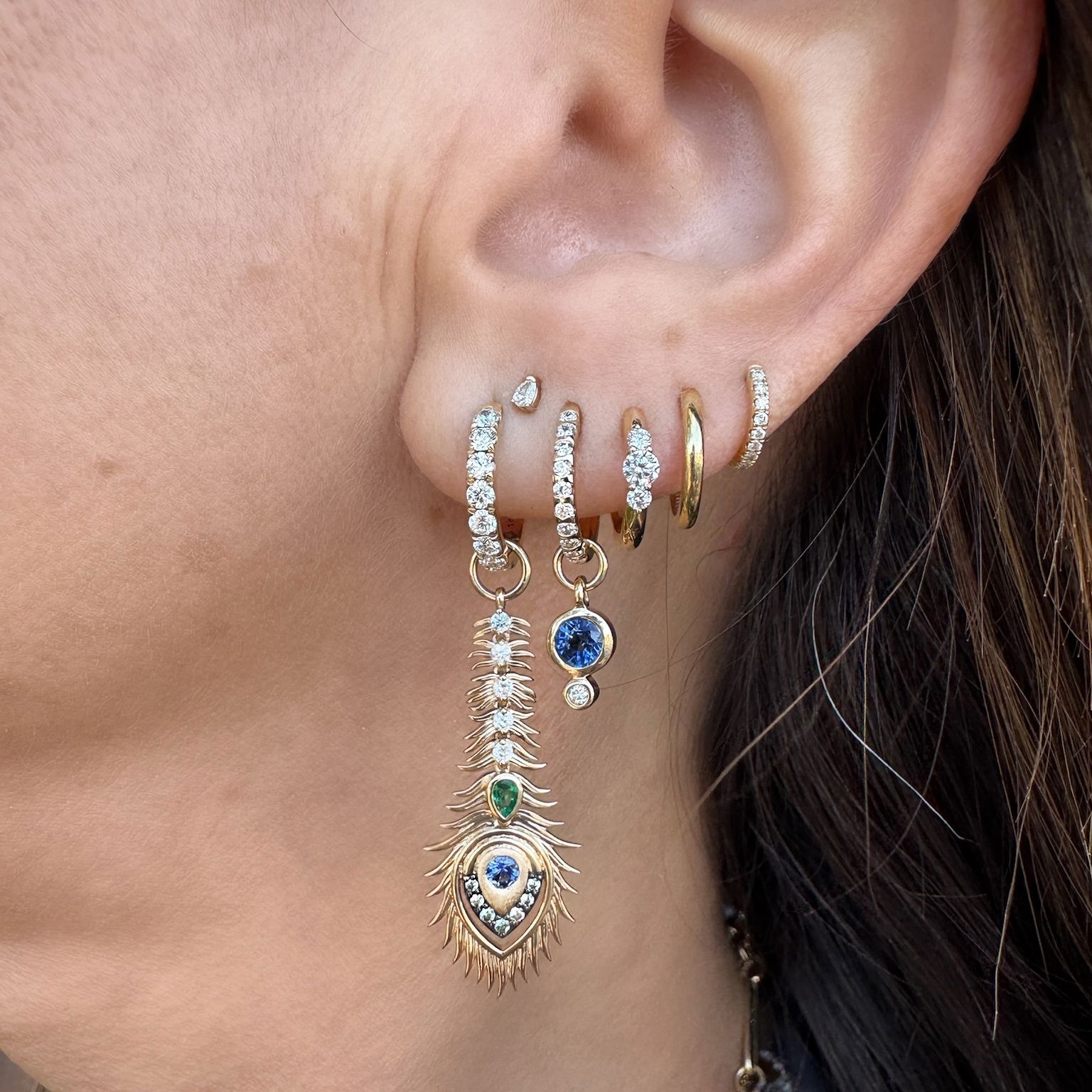 Vibrant round blue sapphire set in 14K yellow gold with hammered bezels make the Classic Tiny Blue Sapphire Earring Charms sparkle. This tiny charm looks amazing on a Three Stories hoop earring or added to a detachable bale and hung on a Three Stories chain necklace or bracelet. Hoops sold separately. Classic Tiny Blue Sapphire Charms
