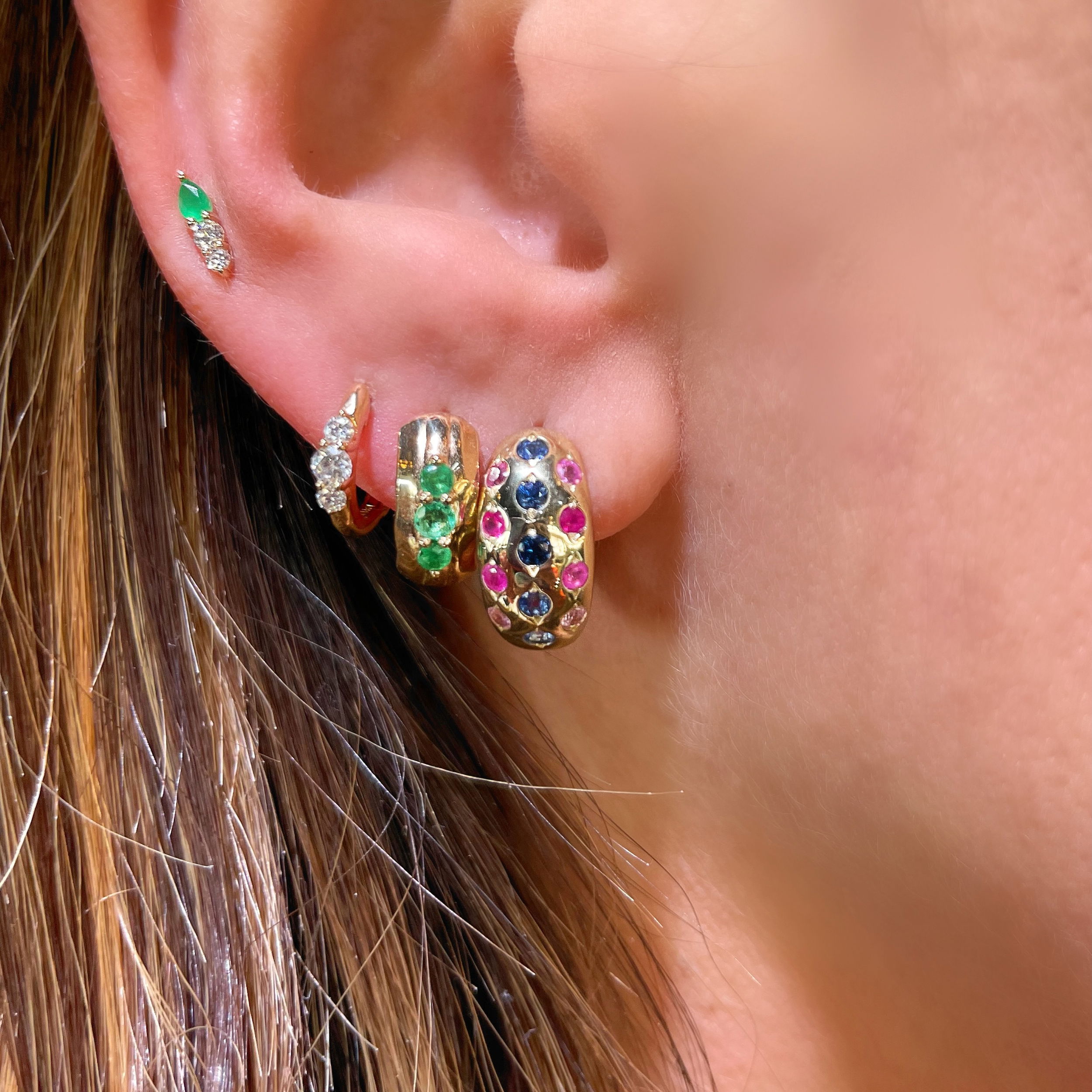 The statement making chubby hoop is here! The Starry Night Double Sided Chubby Hoop Earrings feature sparkling round diamond scattered in a starry night pattern on one side and ombre blue, pink and purple sapphires metal set on the other side. These statement making hoops are made with 14k yellow gold and are a total show stopper.Hoops sold as singles. Starry Night Double Sided Chubby Hoops