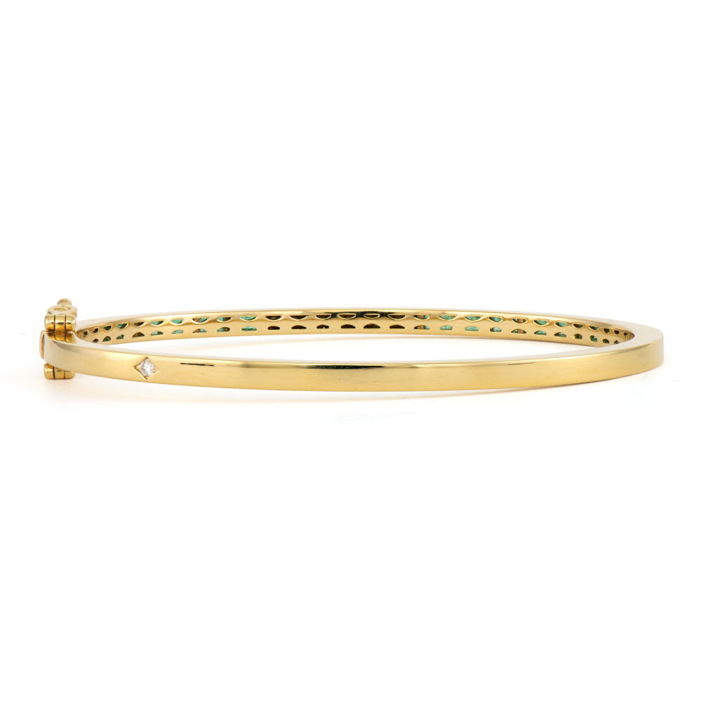 Classic with a twist! The Classic Ombre Sapphire and Diamond Baguette Bangle features baguette ombre sapphires set in 14k yellow gold with prong set round diamonds in the center. This bold sapphire bangle looks amazing alone or stacked in a Three Stories bracelet stack. Size 6.5. Classic Ombre Sapphires and Diamond Baguette Bangle