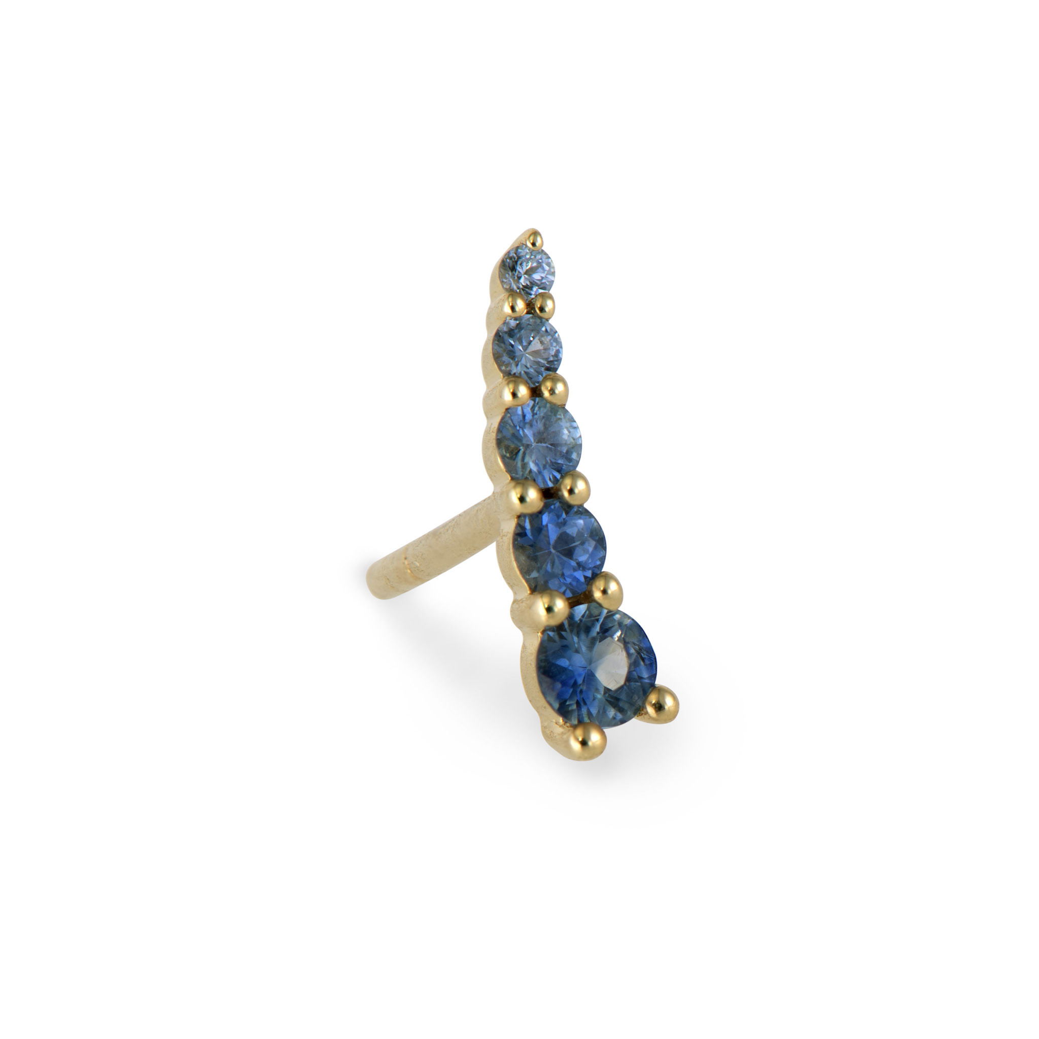 Build your ear stack! The Graduated Blue Sapphire Crawler from the Short Stories Collection is perfect to be worn alone or to help create the perfect Three Stories Jewelry ear stack! Made with 14k yellow gold and blue sapphires, this crawler stud pops! Studs sold as singles. Graduated Ombre Blue Sapphire Crawler