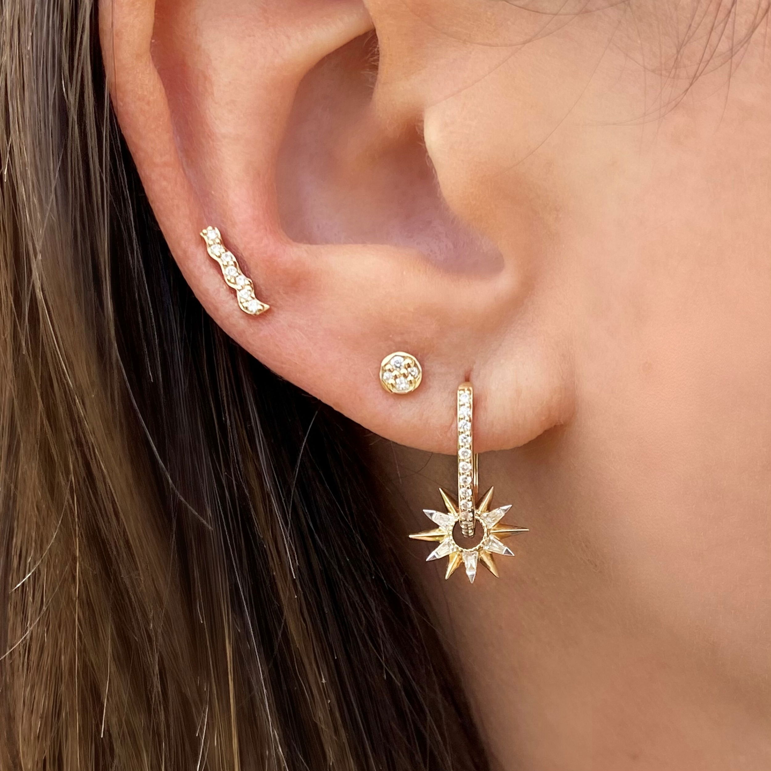Shining bright like the sparkling sea. The Sparkling Sea Pave Bar Studs are made with 14k yellow gold and sparkling rounds diamonds. They can be worn as an earring or a crawler. Studs sold as singles. Sparkling Sea Pave Bar Studs