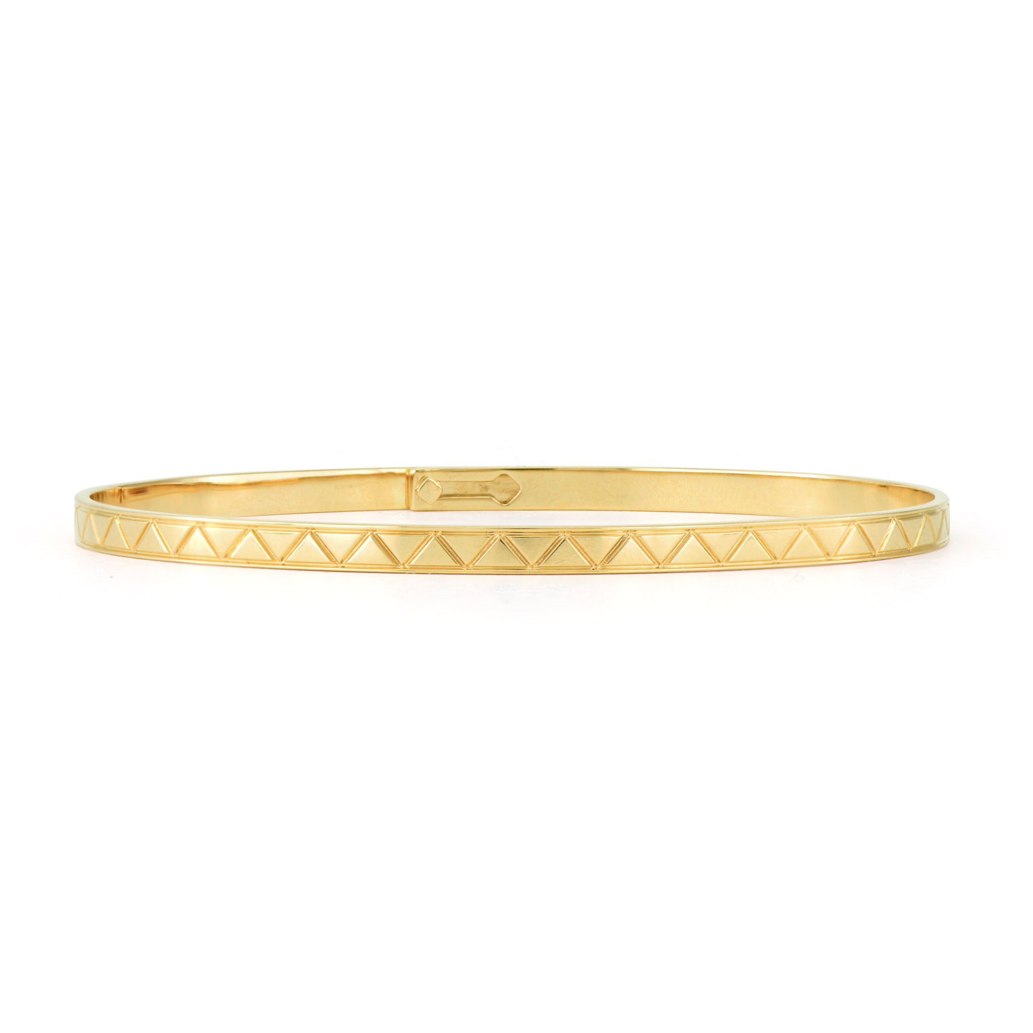 This Engraved Pyramid Eternity Bangle features a striking geometric design crafted in 14K yellow gold. The surface of the bangle is meticulously engraved with a continuous pattern of pyramid shapes, creating a textured, three-dimensional effect that catches the light from every angle. This innovative texture adds visual interest and tactile appeal to the classic bangle form. The flexible design ensures a comfortable fit, while the hidden closure maintains the seamless eternity effect. This versatile piece works beautifully alone or stacked with other bangles for a more dramatic look. Size 6.5. Engraved Pyramid Eternity Bangle