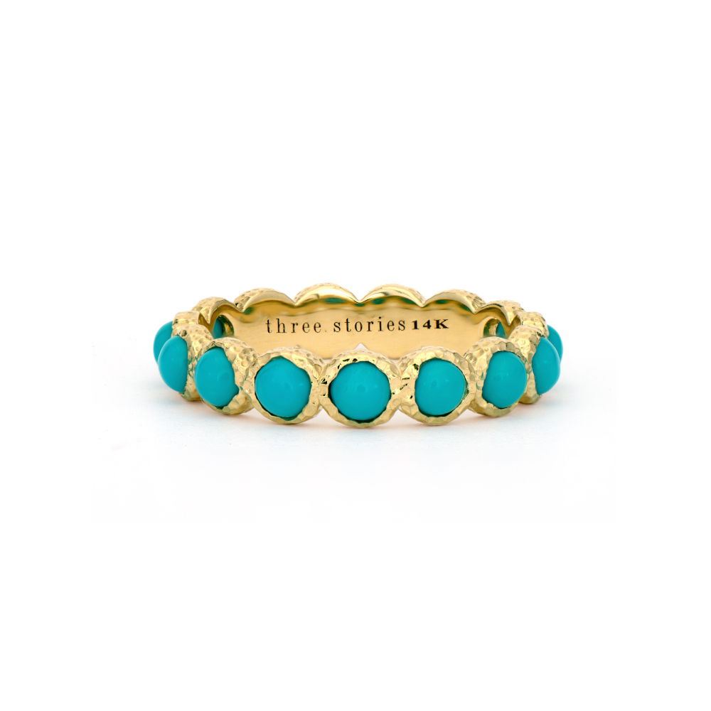 At Three Stories, turquoise is a neutral! The Classic Gold and Turquoise Band is statement making but perfect to wear everyday. Made from 14k yellow gold and natural turquoise, this band features hammered bezels to make it truly unique. Wear alone or in a Three Stories ring stack. Size 7 Classic Gold and Turquoise Band